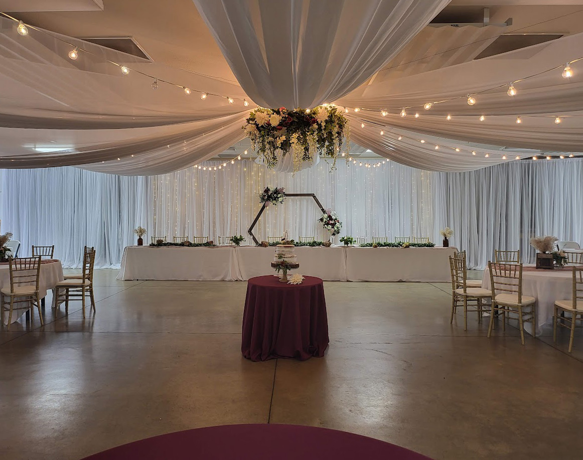 Backdrop, ceiling treatment, and guest table design for a wedding in northern Ohio. 