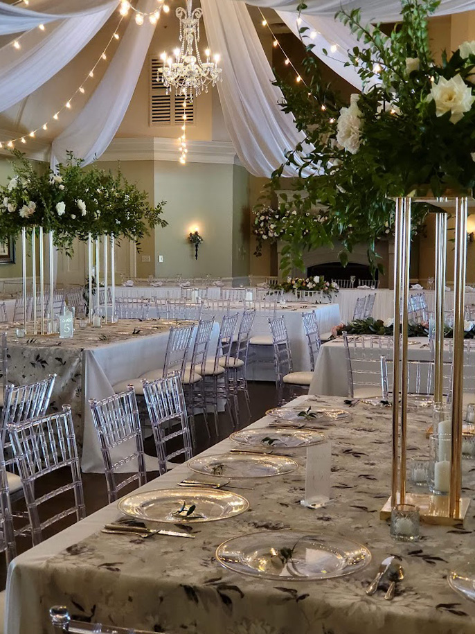 Plum Brook wedding design with ceiling treatment and guest table decoration.