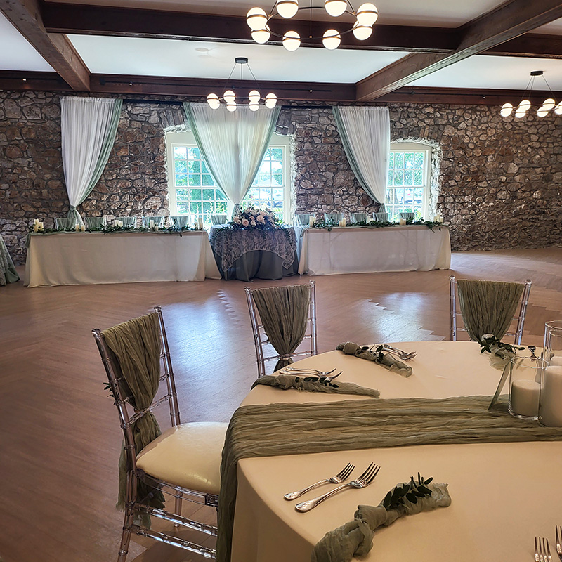 Green and blue reception design with backdrop and table setting.