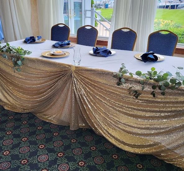 Sequin linen in gold with a gold broach.