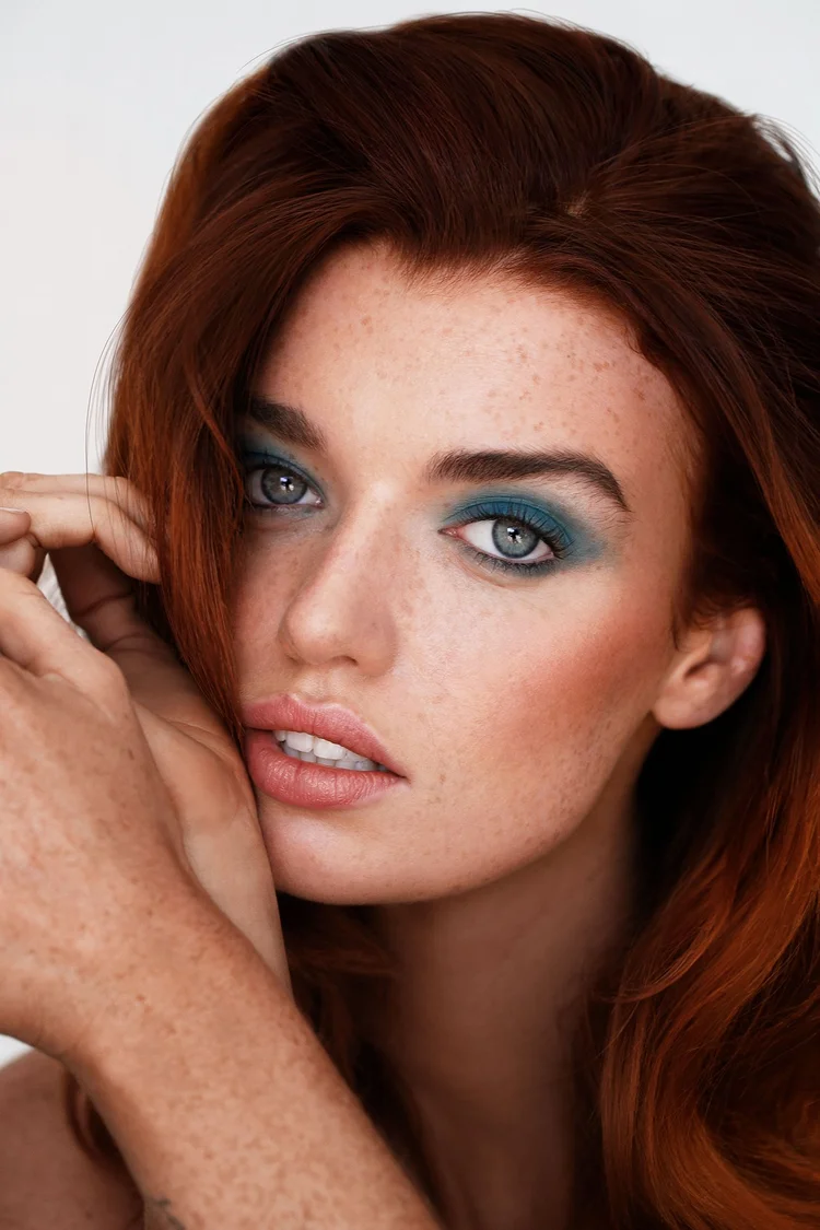 Lifestyle photo of model with beauty product in studio