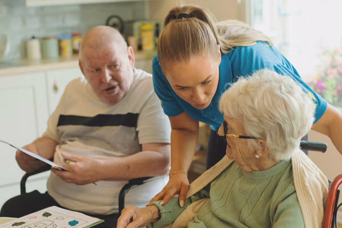An aged Care worker assisting a female resident