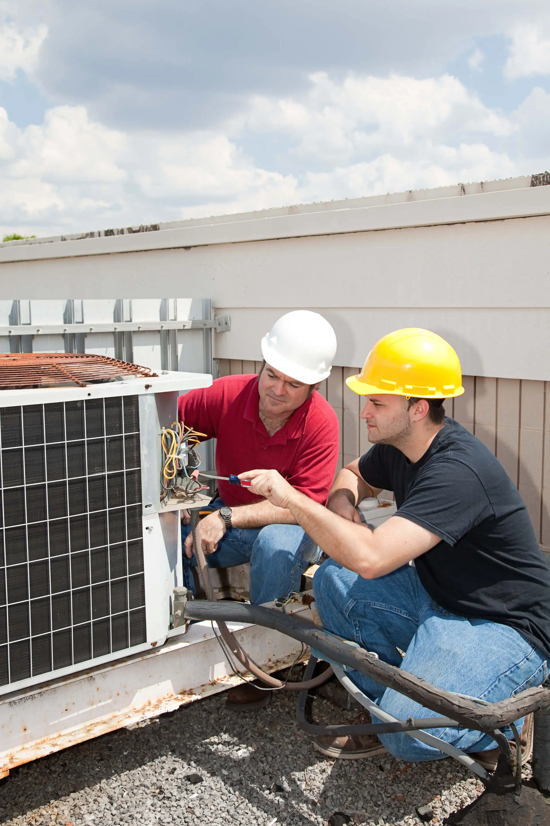 technicians working on air conditioner