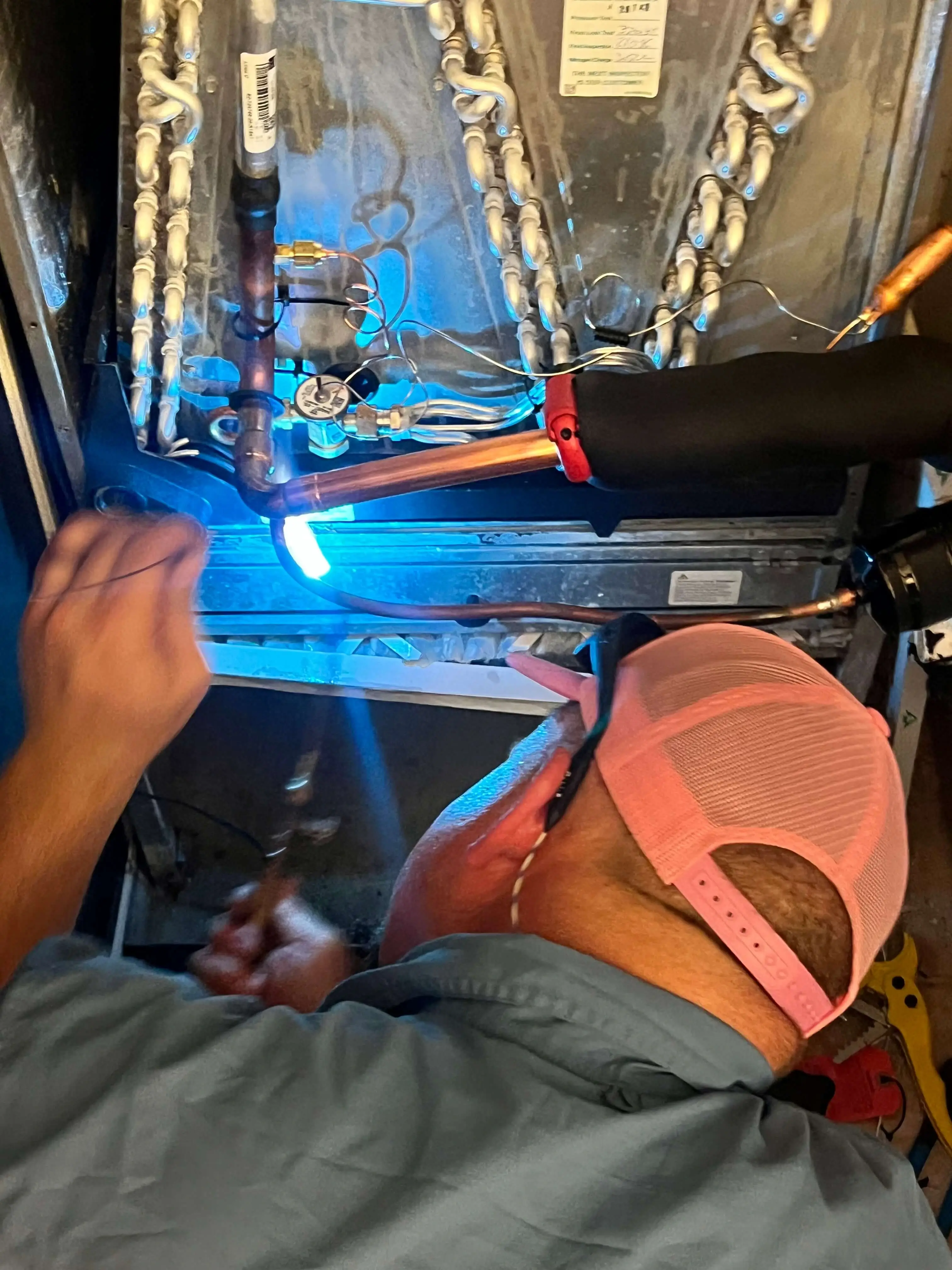 technician repairing a HVAC system