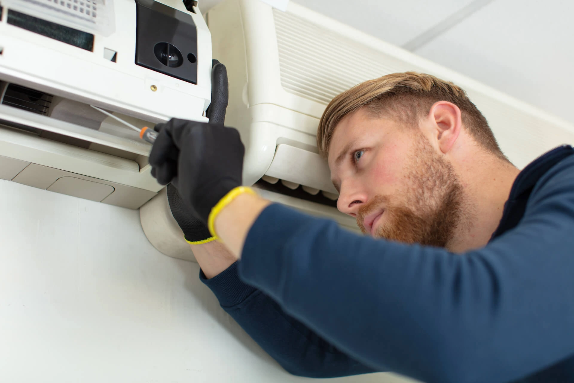 hvac technician working on an ac