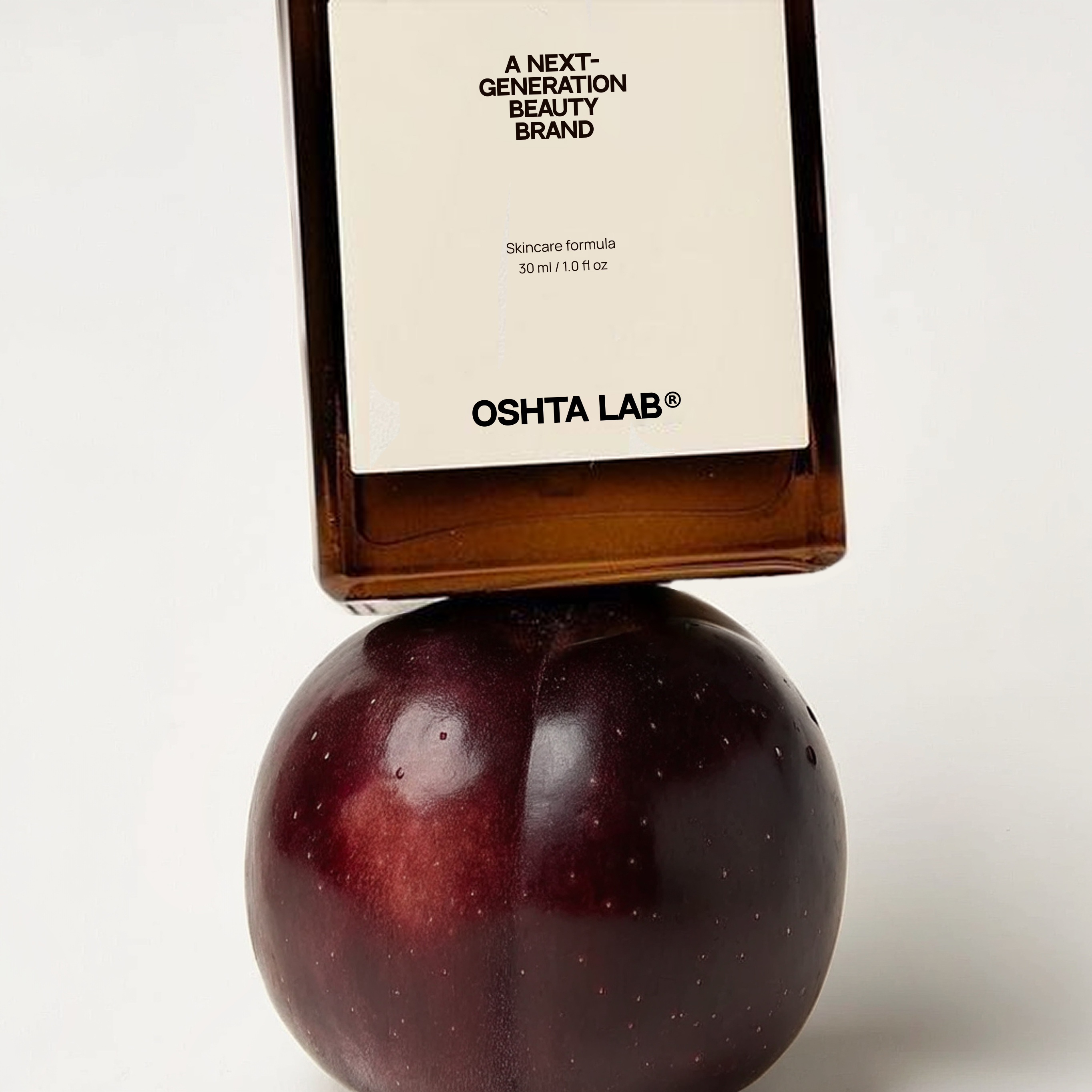 A bottle of OSHTA LAB standing on a plum