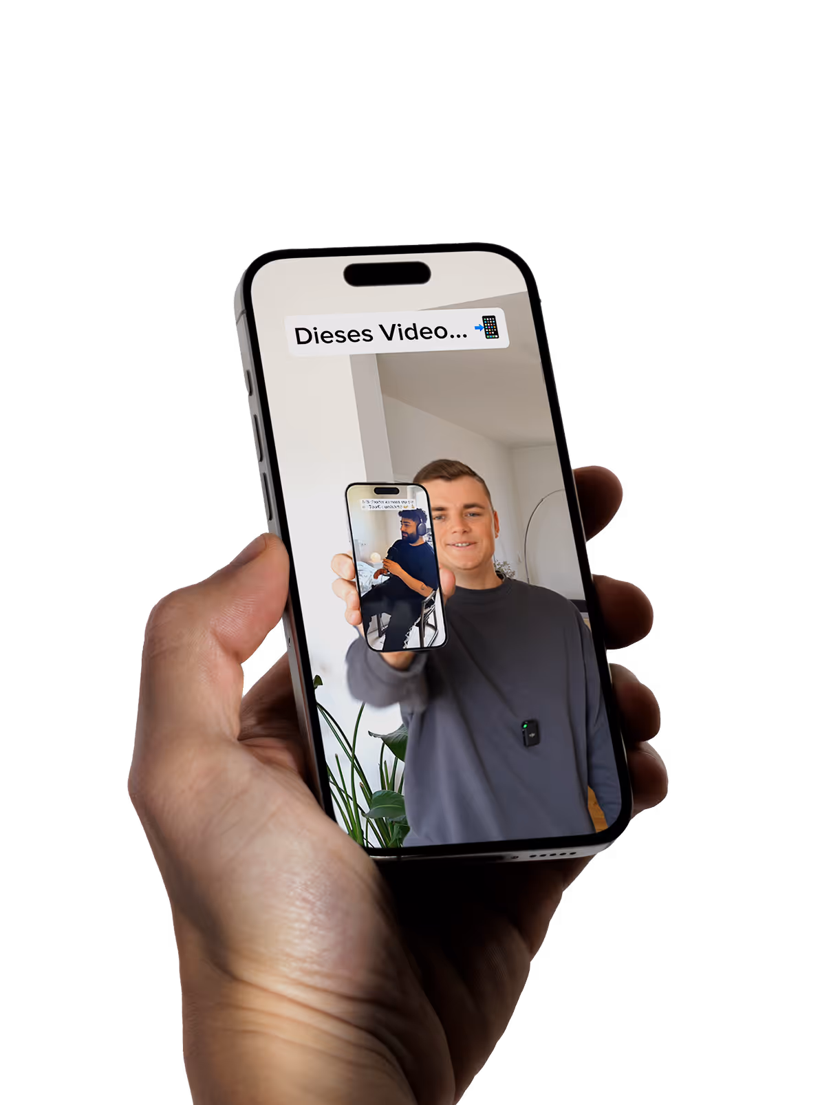 A man holding a cell phone with a picture of himself on the screen.