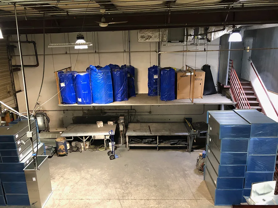 Industrial storage room with blue wrapped packages and metal shelving