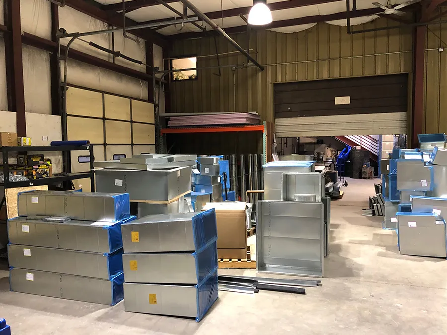 Stacked metal containers and storage shelves