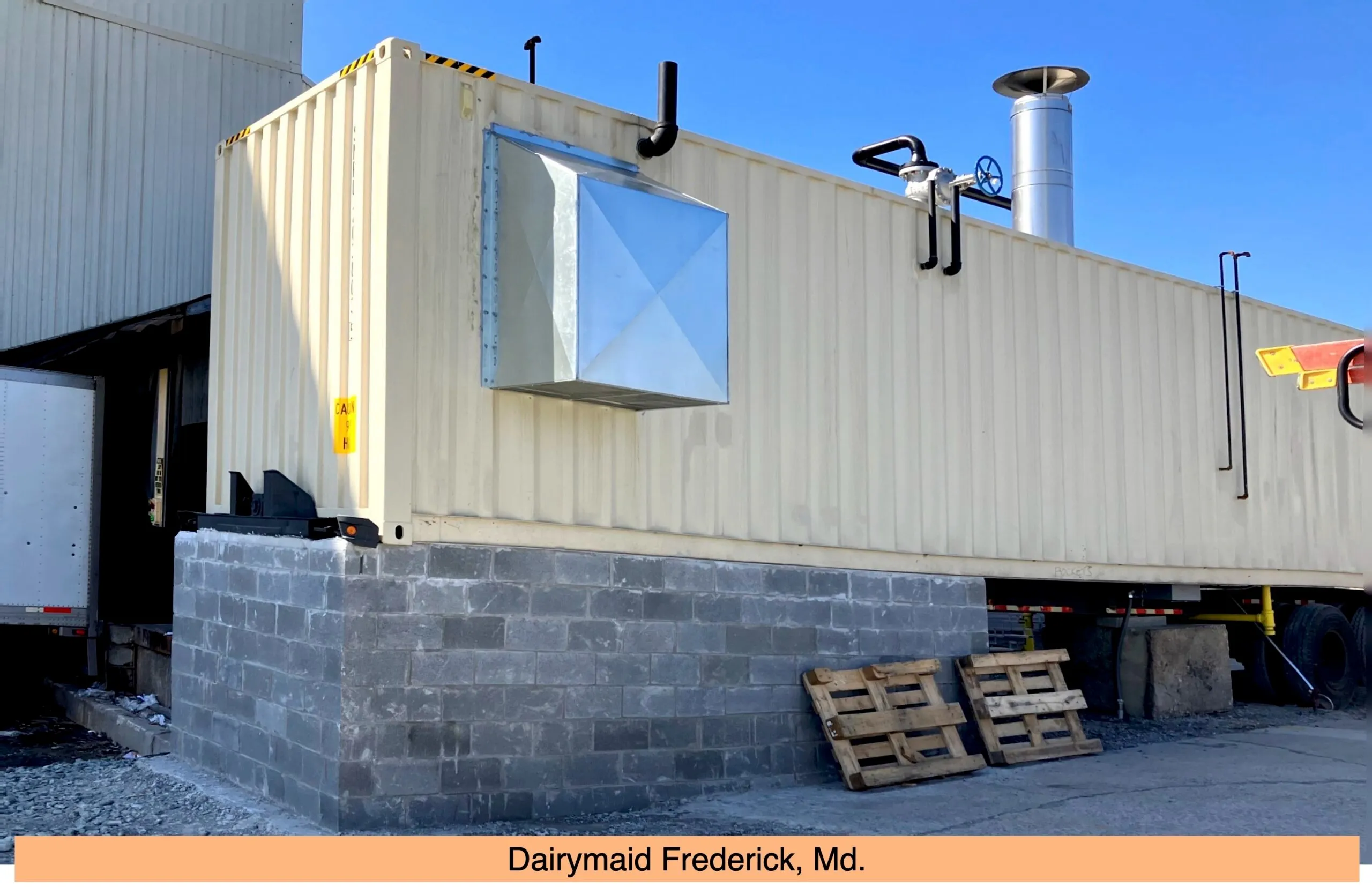 Shipping container with window on concrete block foundation at Dairymaid facility