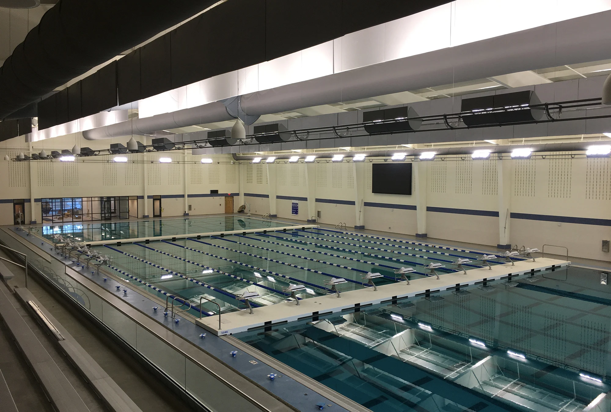 A high-angle view of a large indoor swimming pool.
