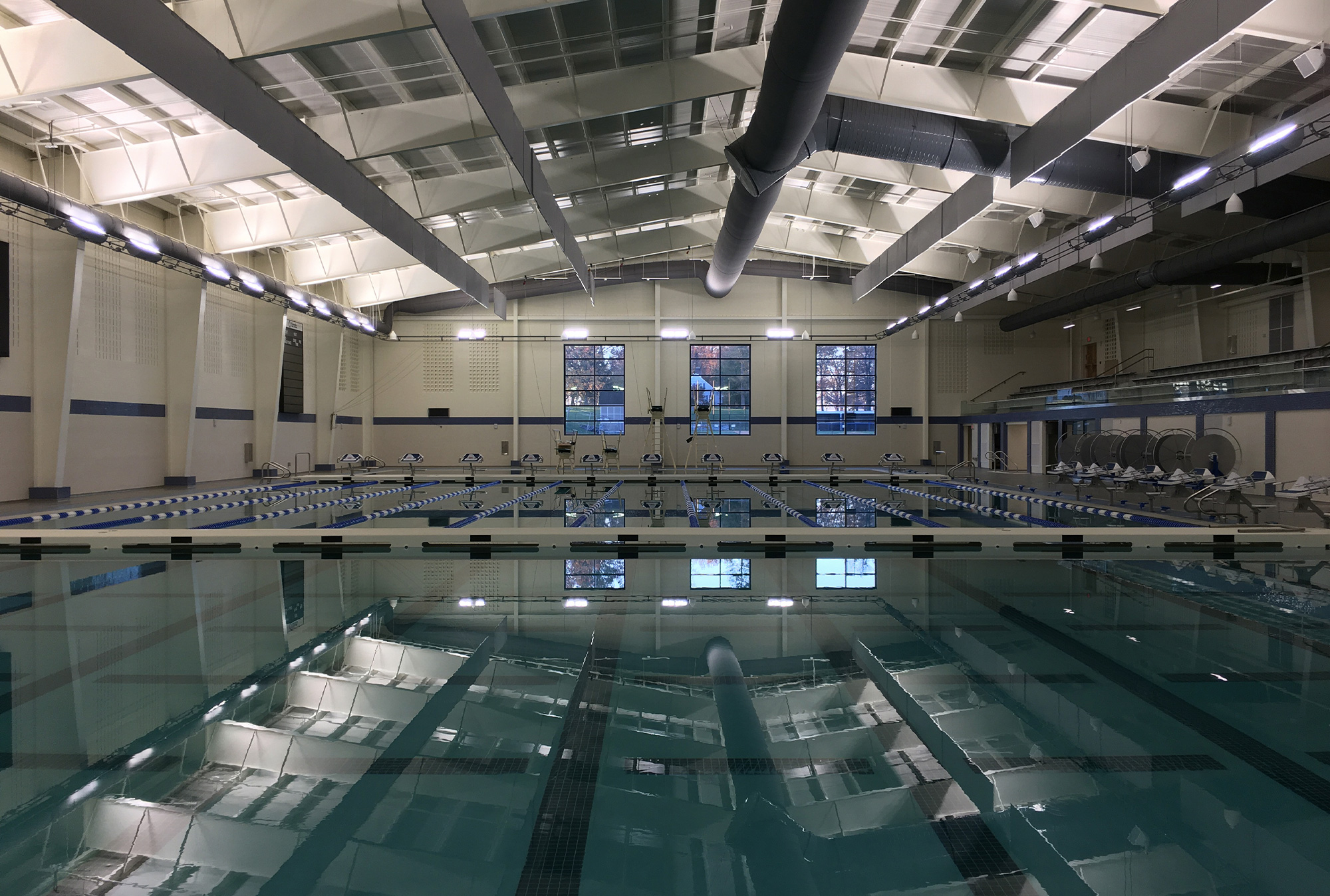 A large empty swimming pool with a high ceiling.