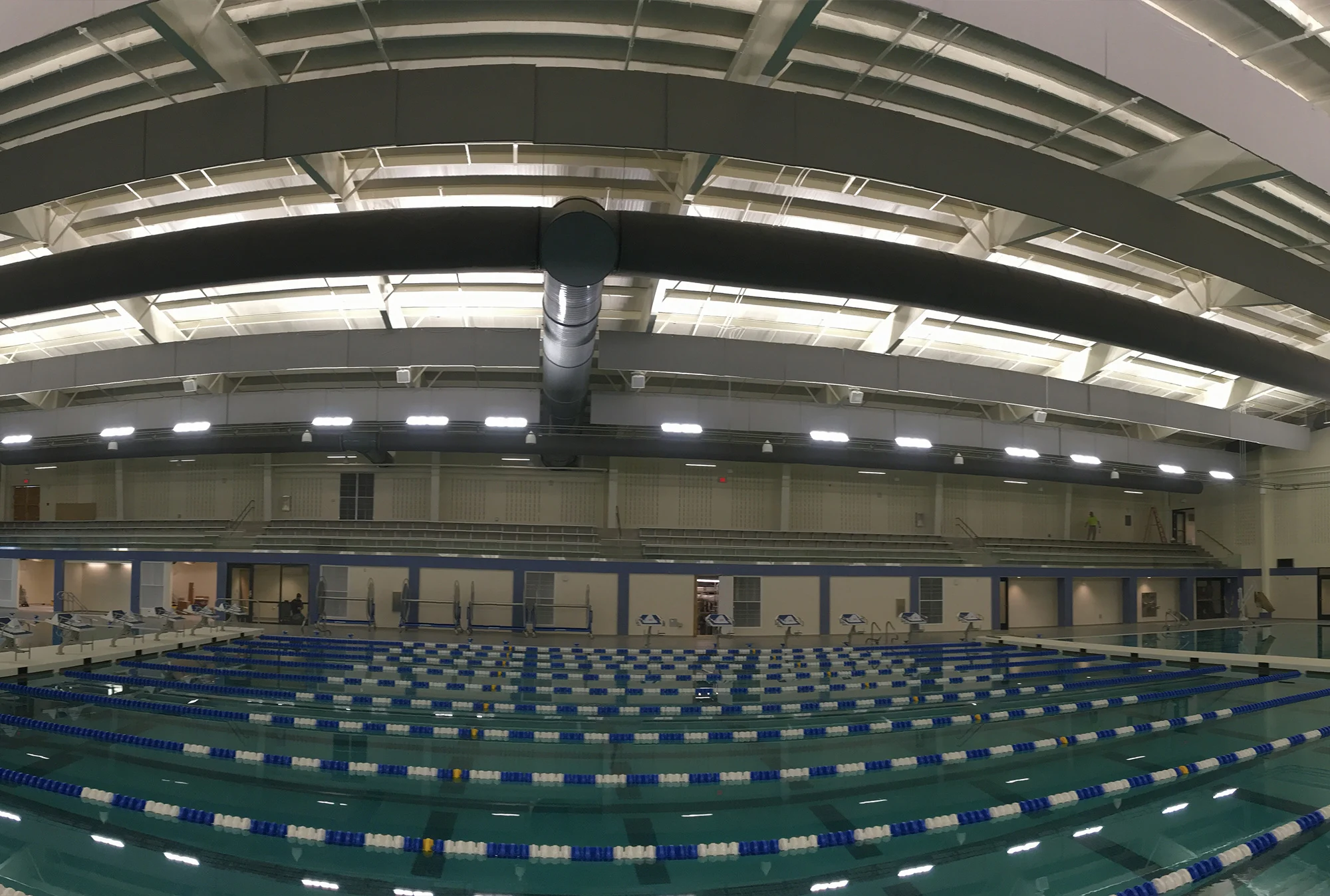 A very wide shot of an empty indoor swimming pool.