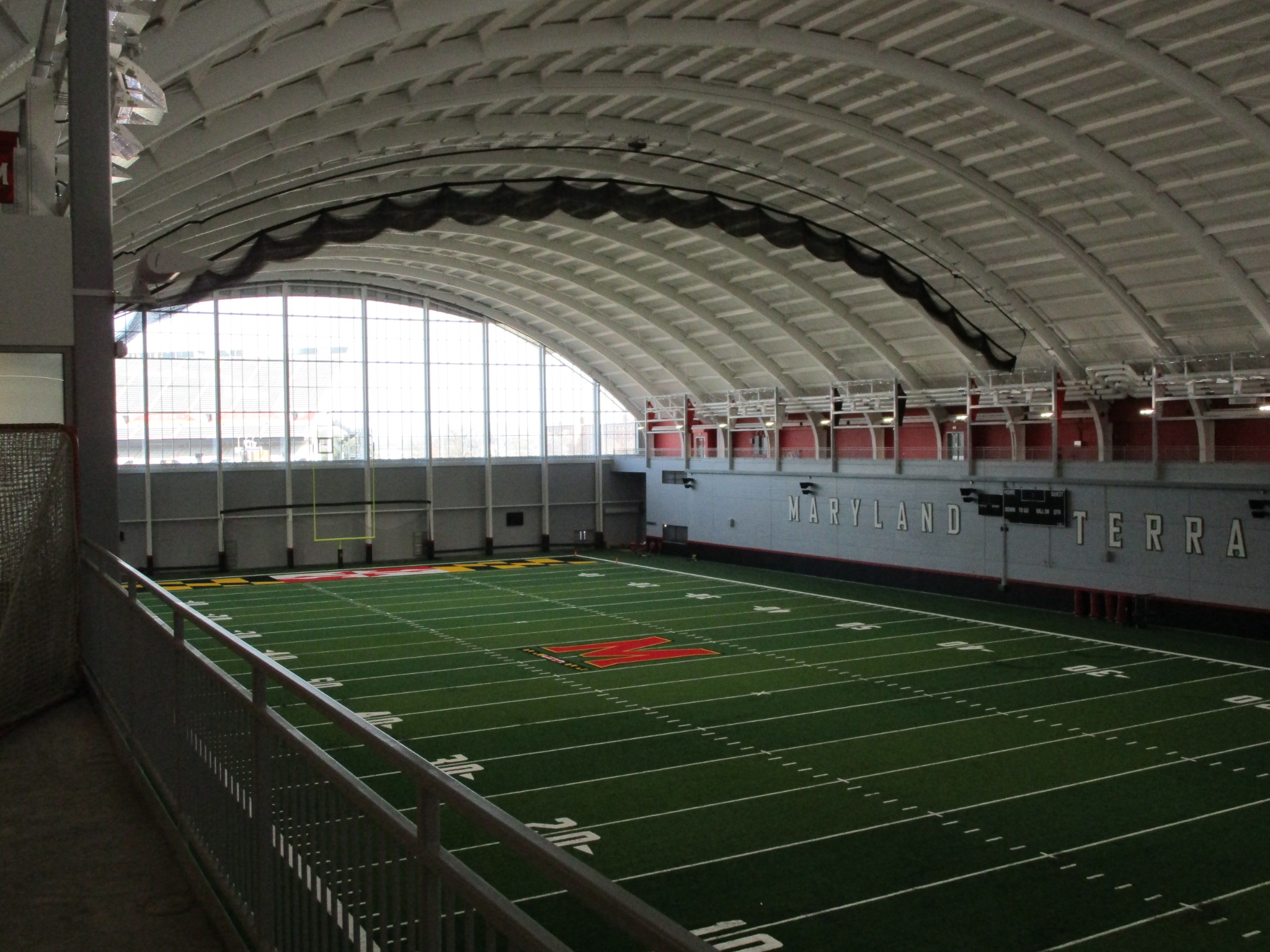 An indoor sports arena with an arched ceiling.