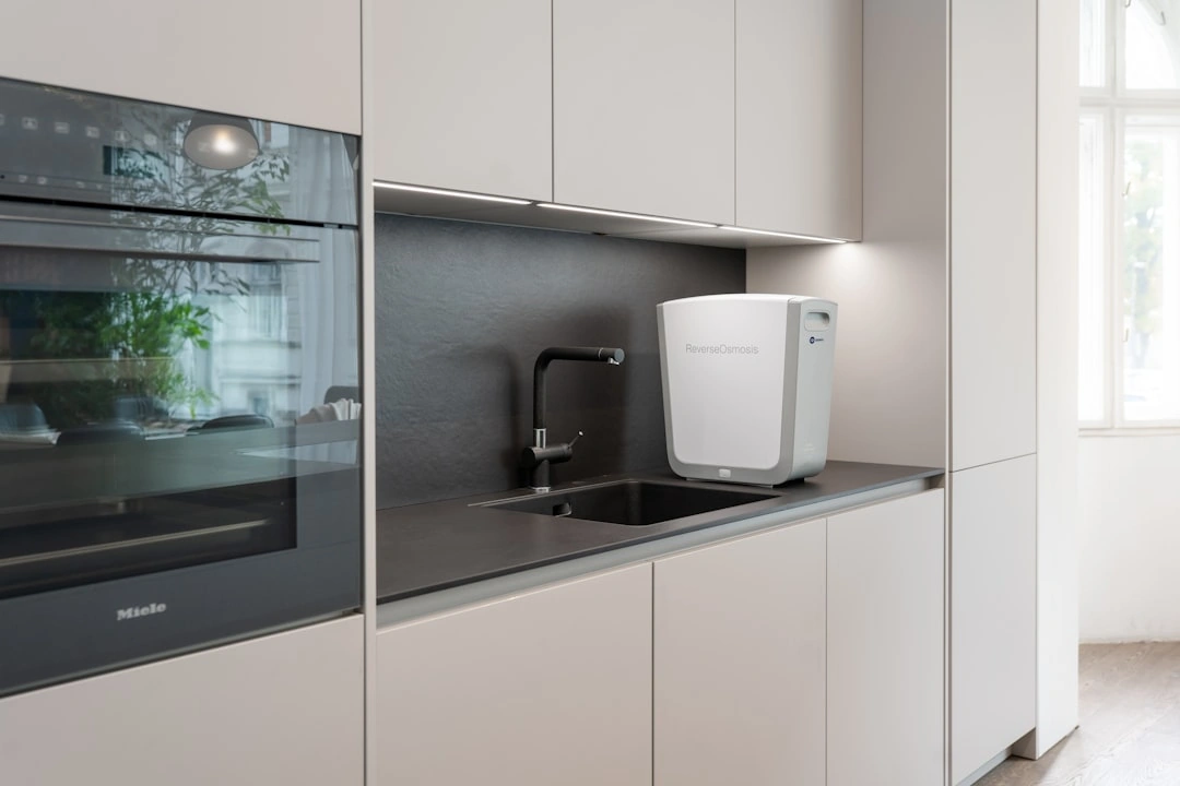 compact wall-mounted tankless unit in a clean utility room compact wall-mounted tankless unit in a clean utility room