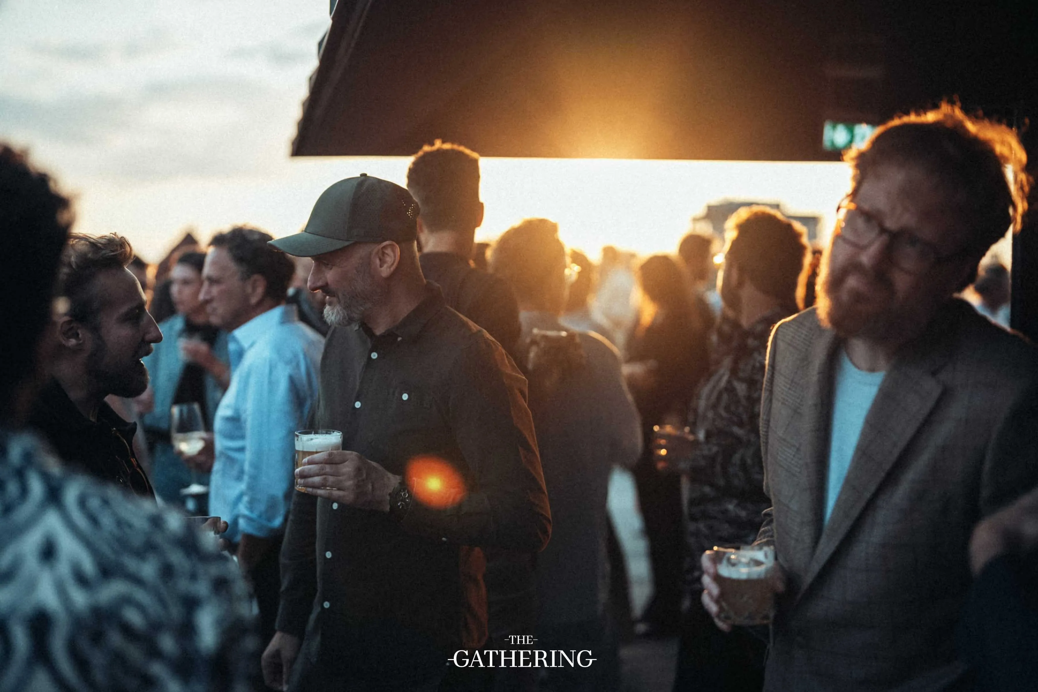 Crowd mingling with drinks at The Gathering hosted by Maison ACME