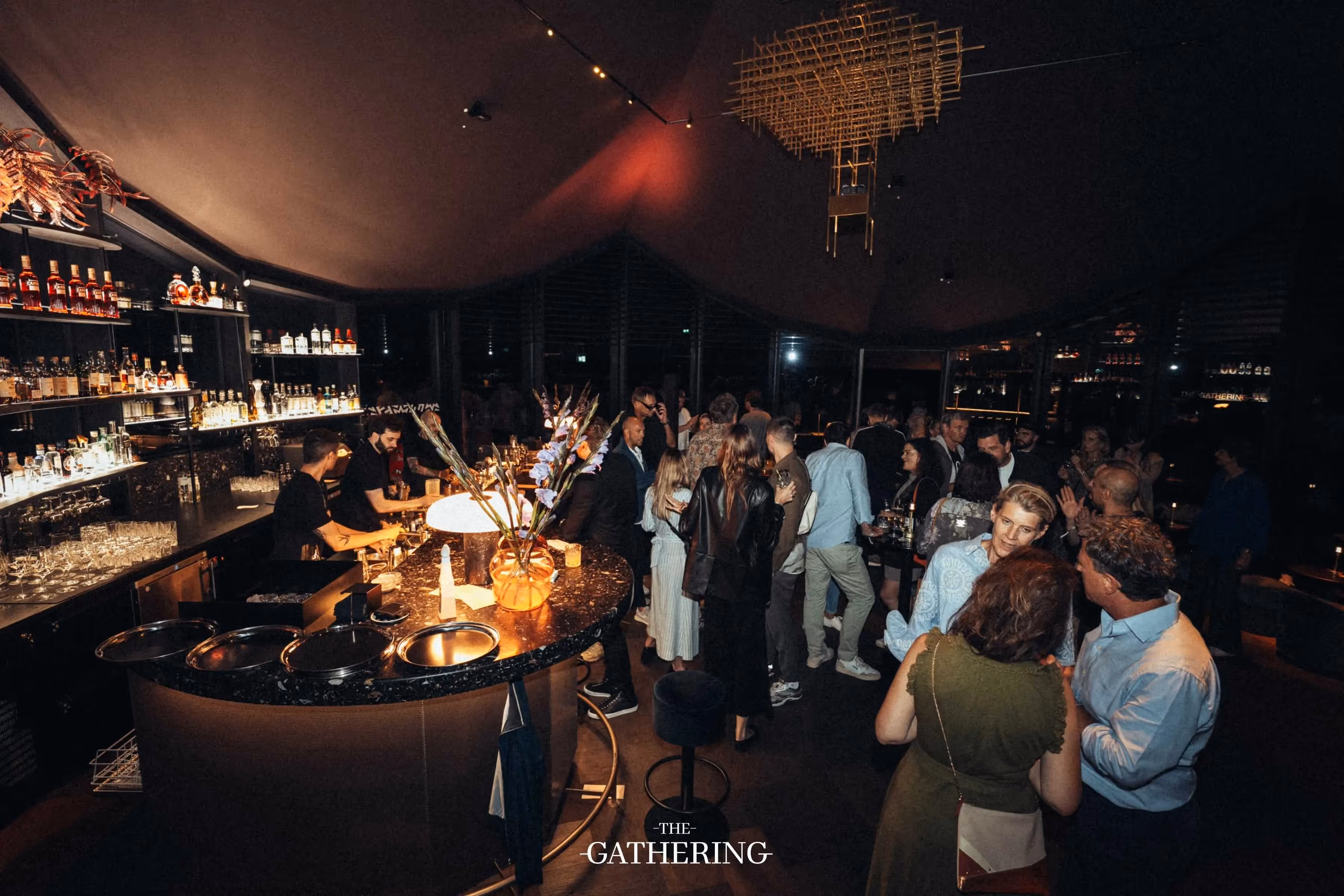 Crowd mingling with drinks at The Gathering hosted by Maison ACME