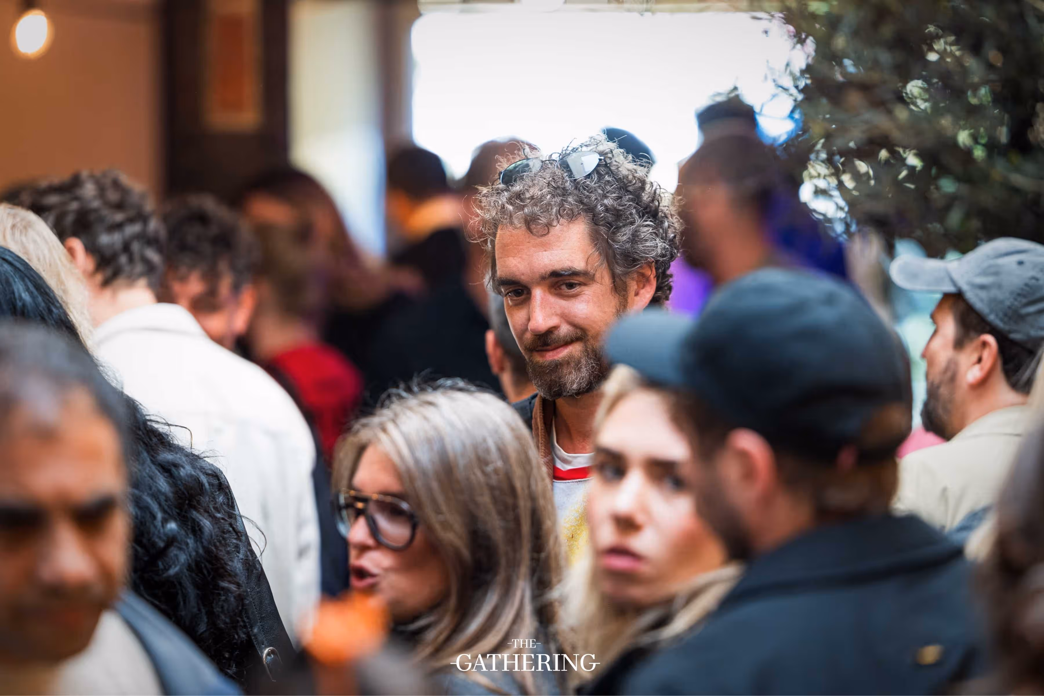Crowd mingling with drinks at The Gathering hosted by Maison ACME