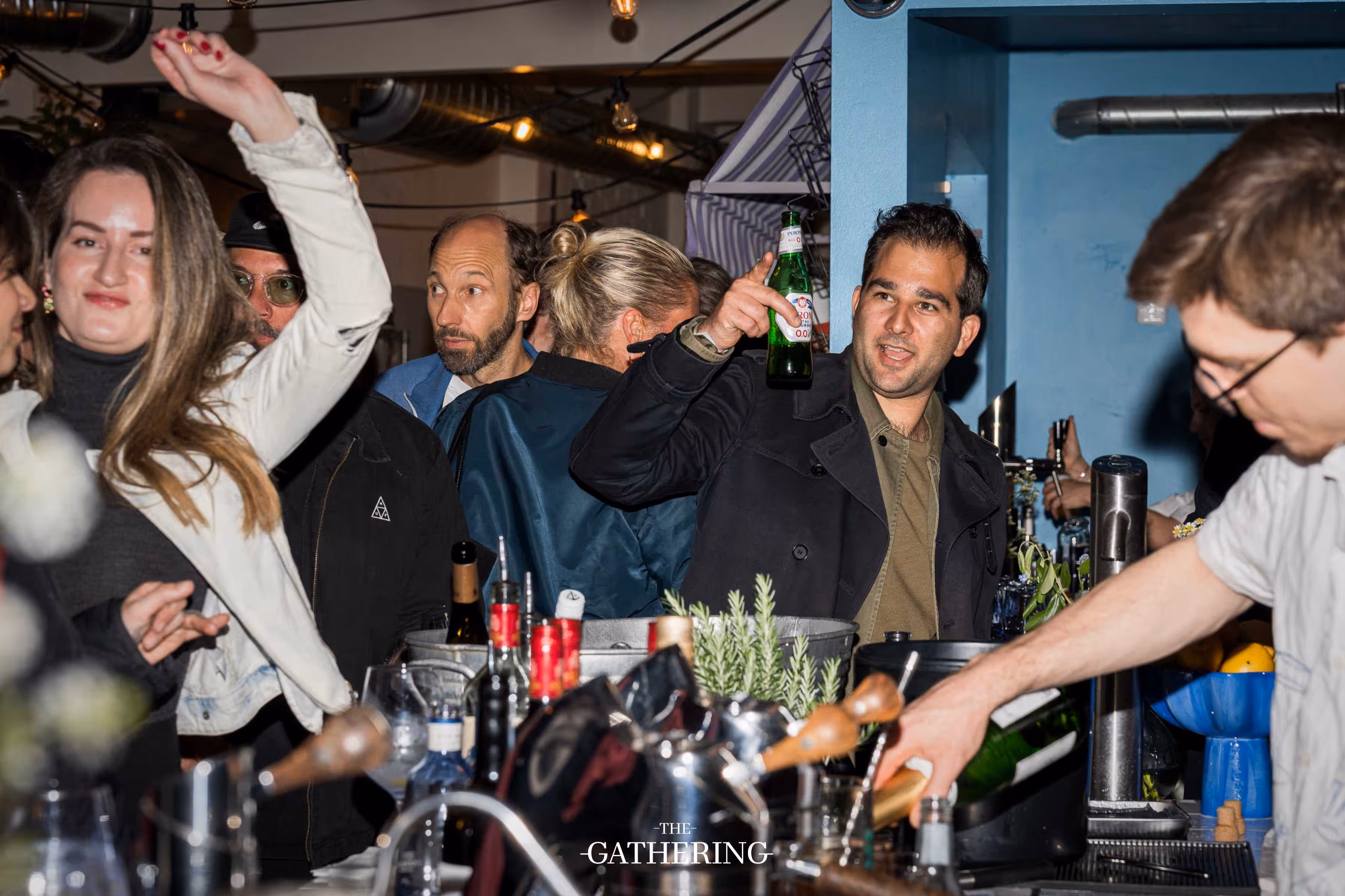 Crowd mingling with drinks at The Gathering hosted by Maison ACME