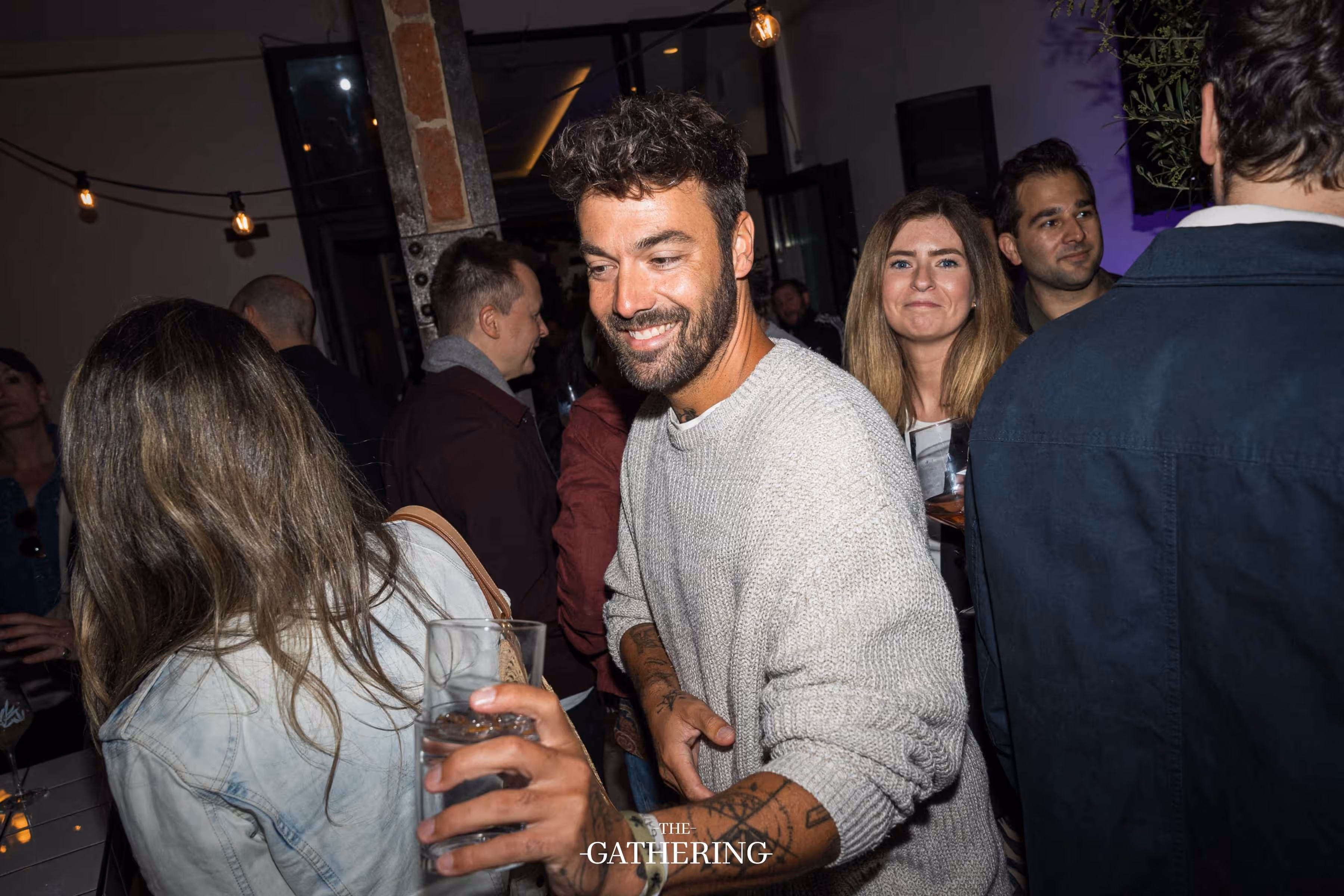 Crowd mingling with drinks at The Gathering hosted by Maison ACME