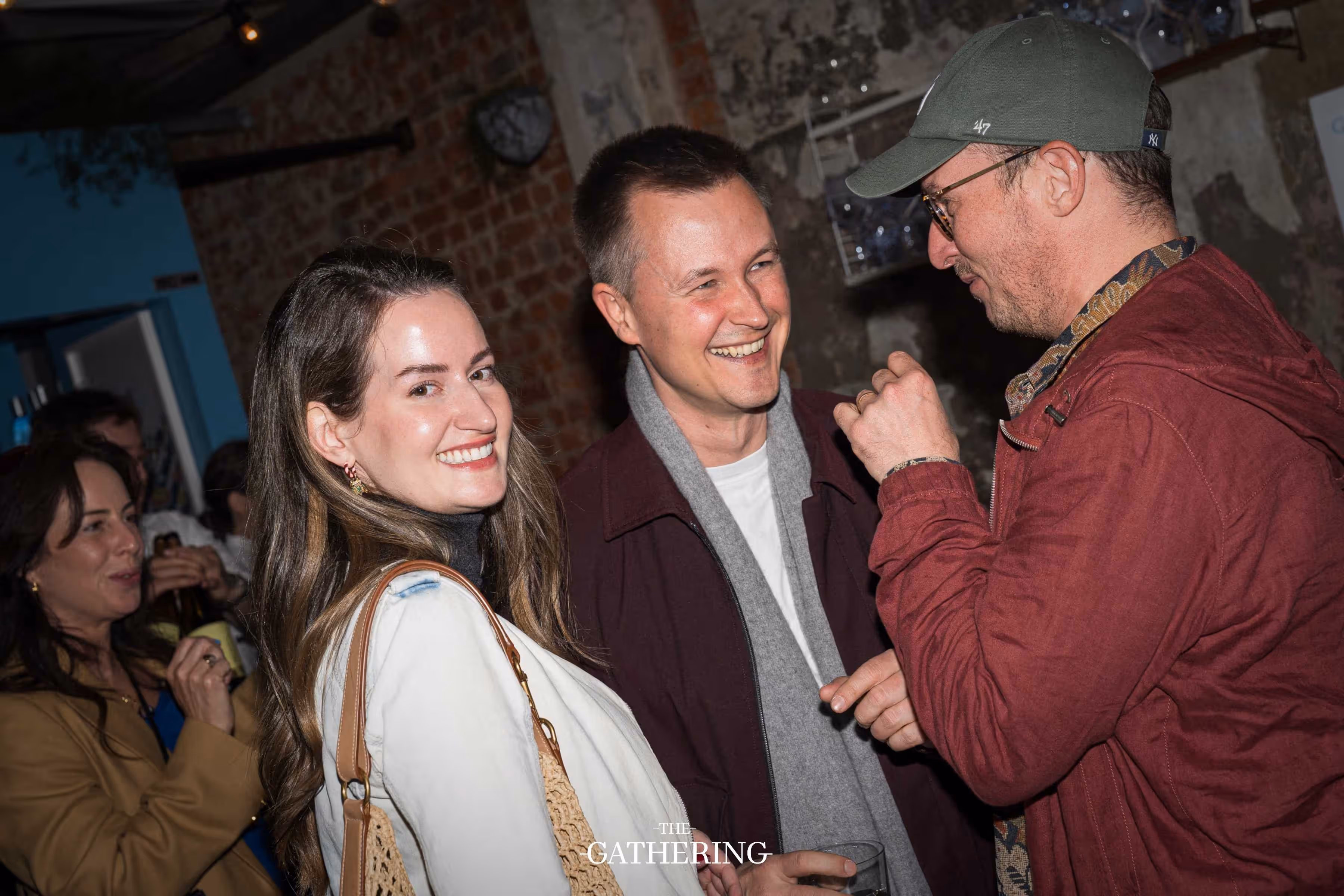 Crowd mingling around tables with drinks at The Gathering hosted by Maison ACME