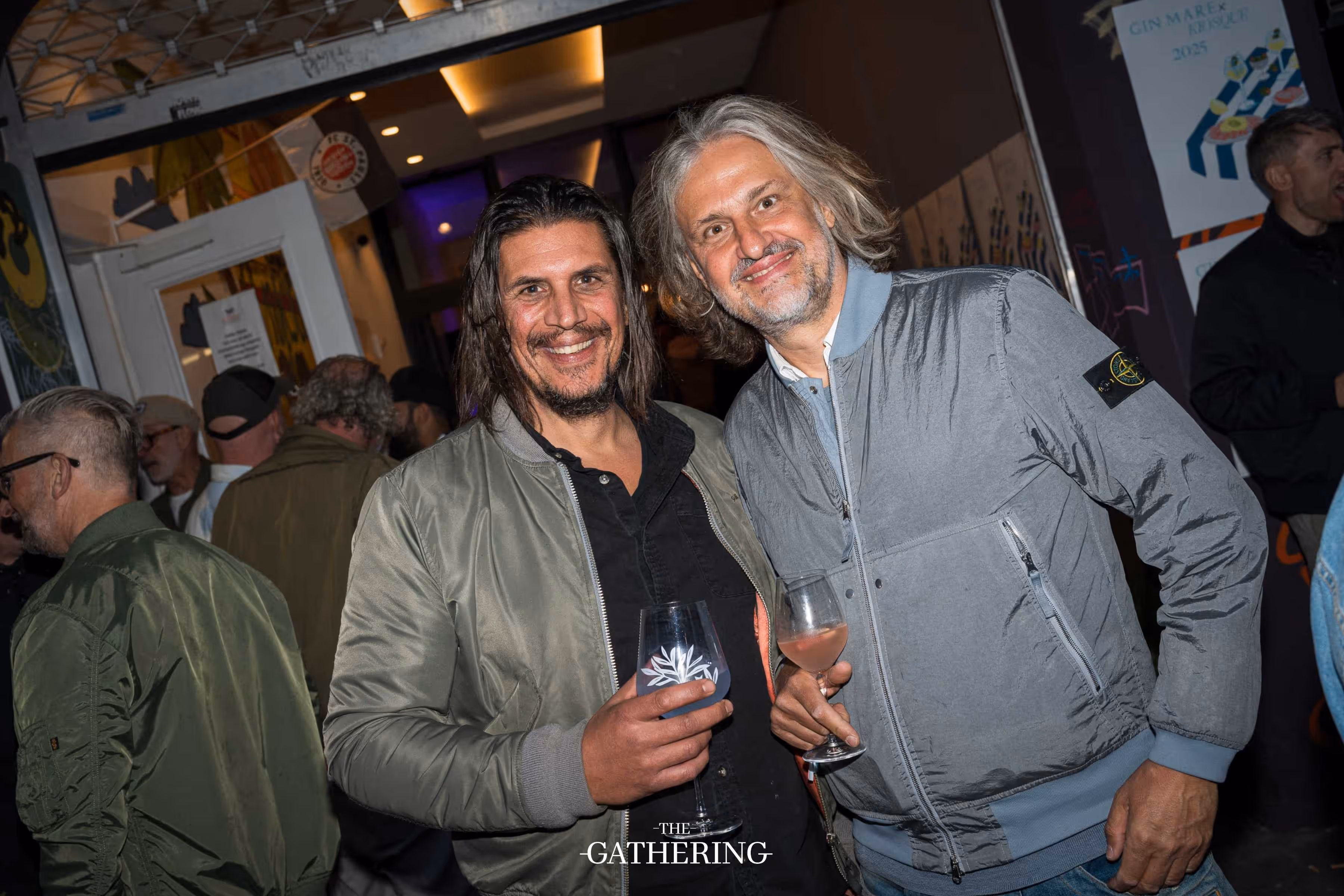 Crowd mingling around tables with drinks at The Gathering hosted by Maison ACME