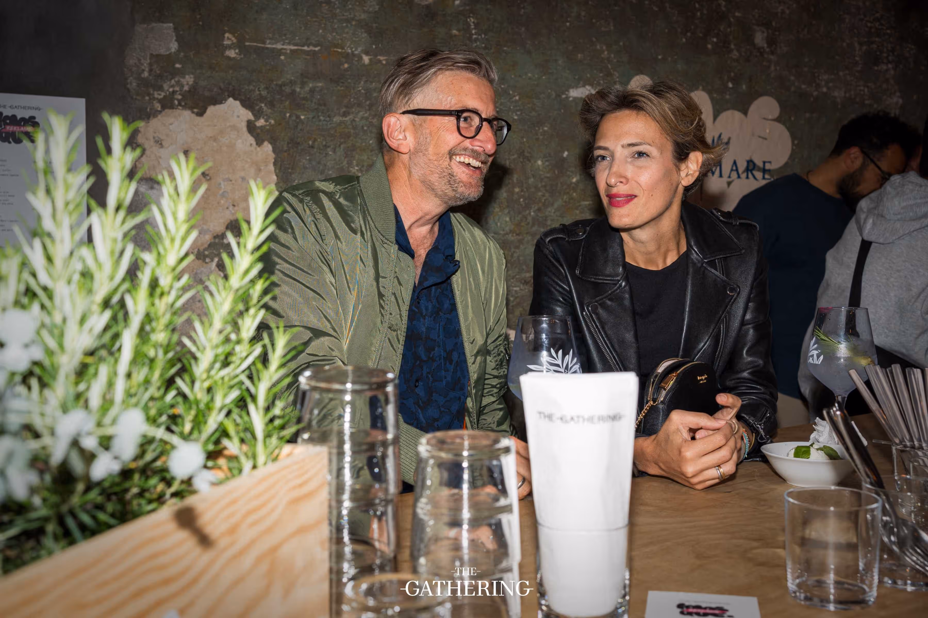 Crowd mingling around tables with drinks at The Gathering hosted by Maison ACME