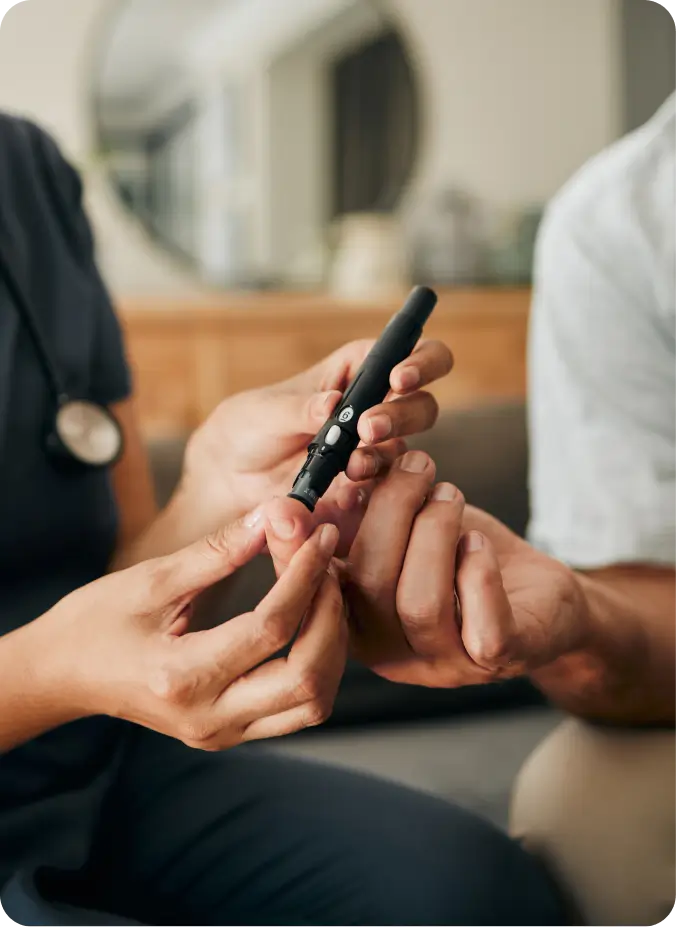 Nurse taking a finger-prick sample at home