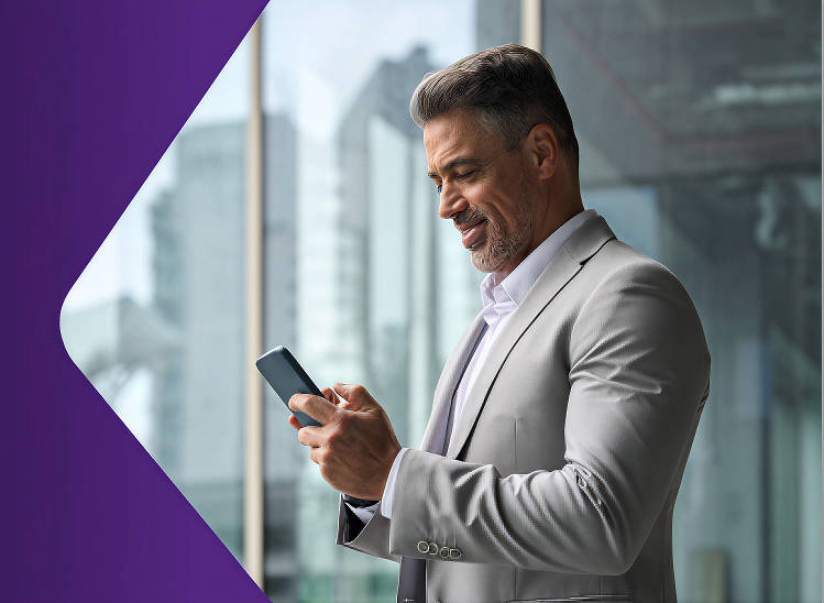 Detail of Proximus logo and a man in a suite holding a mobile device in front of a business skyline
