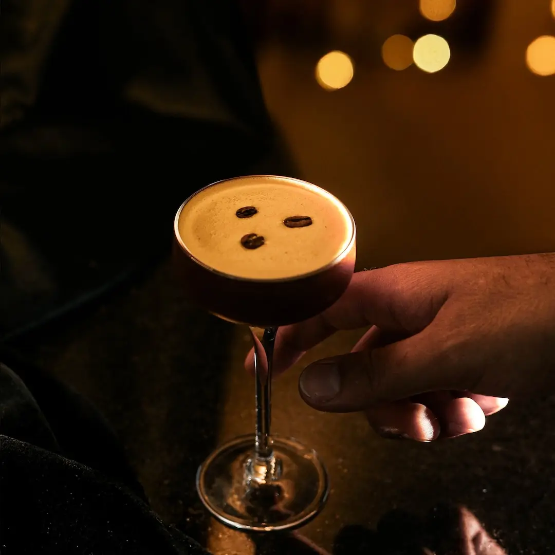 Non-alcoholic Espresso Martini cocktail on a table with a dark background
