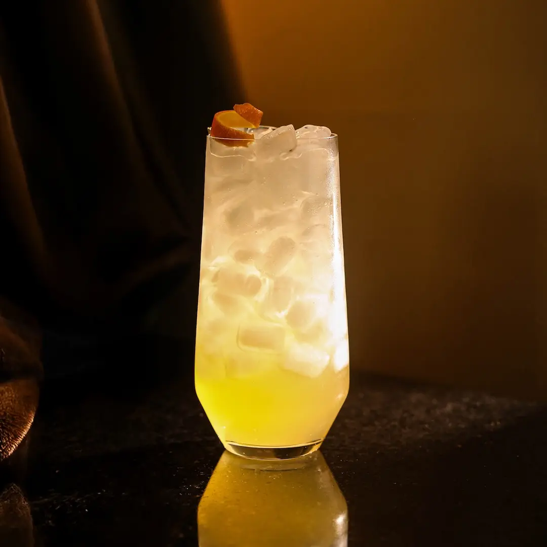 Non-alcoholic Orange fizz cocktail on a dark background
