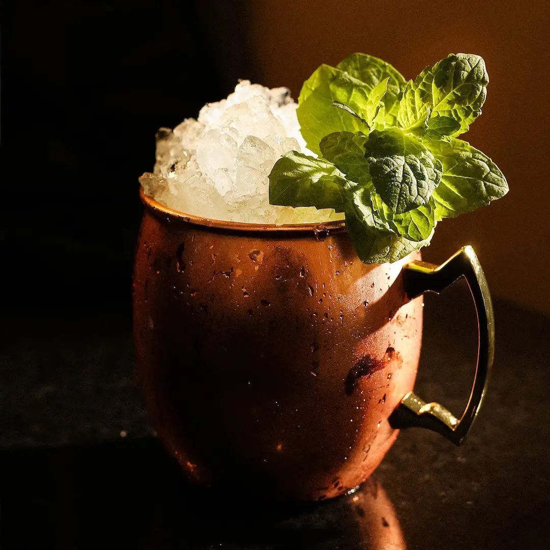 Non-alcoholic Dark and stormy cocktail on a dark brown background