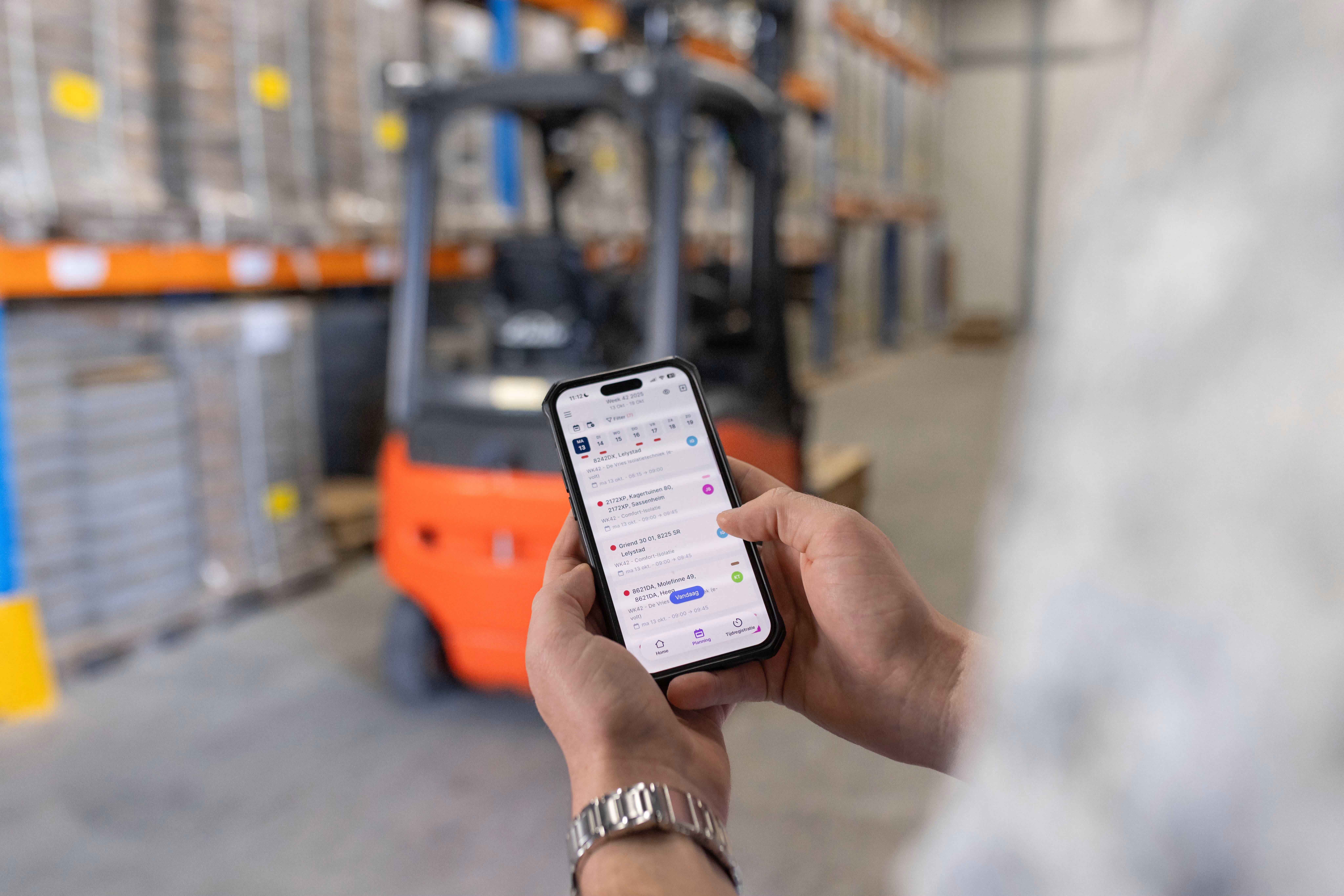 Event planner reviewing site layout and using vPlan on a smartphone to manage tasks and schedules on-site.