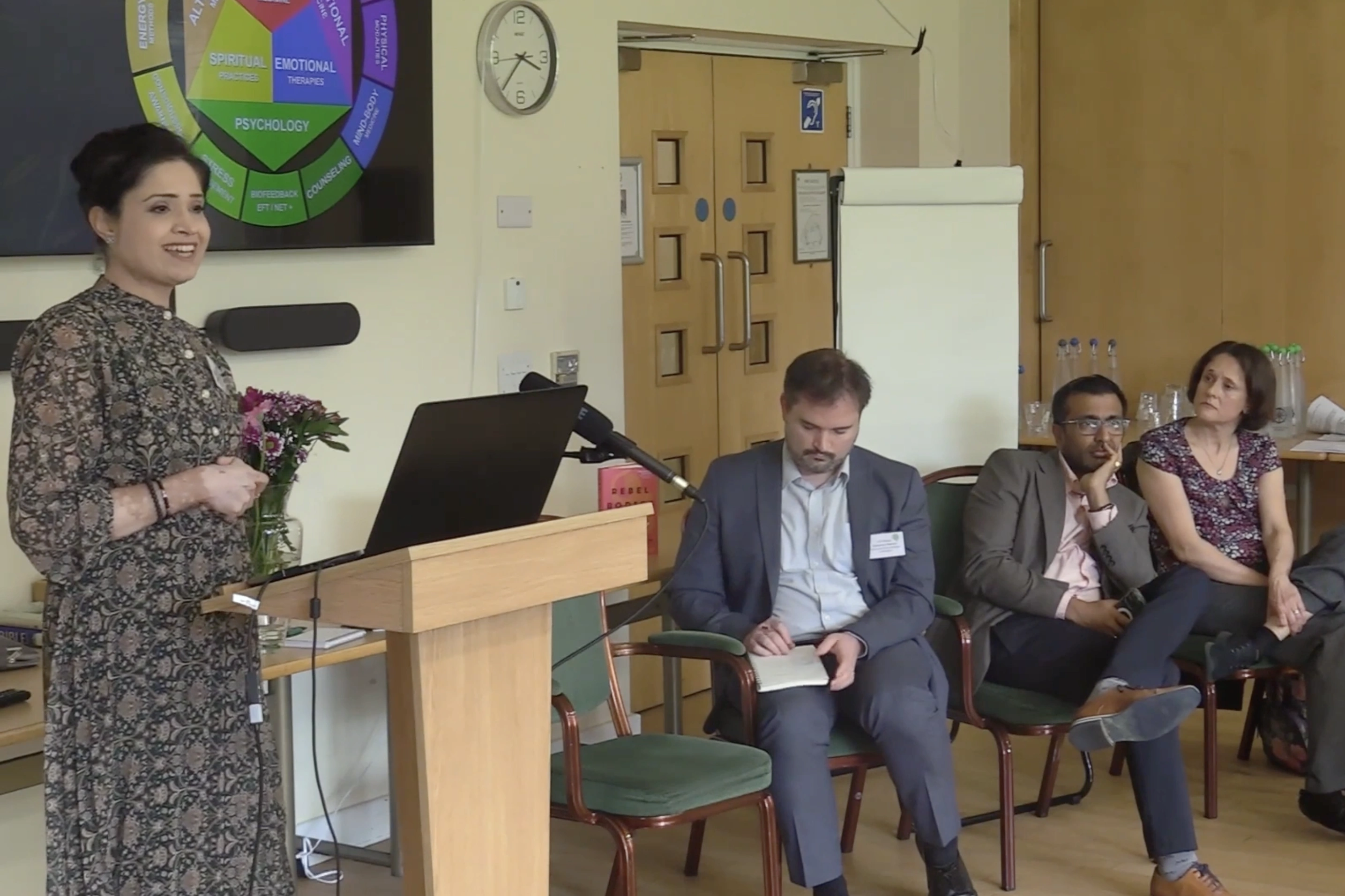 Dr Minha Rajput-Ray presenting on supportive therapies and integrative approaches at the FPOD Medically Unexplained Symptoms conference, 2024