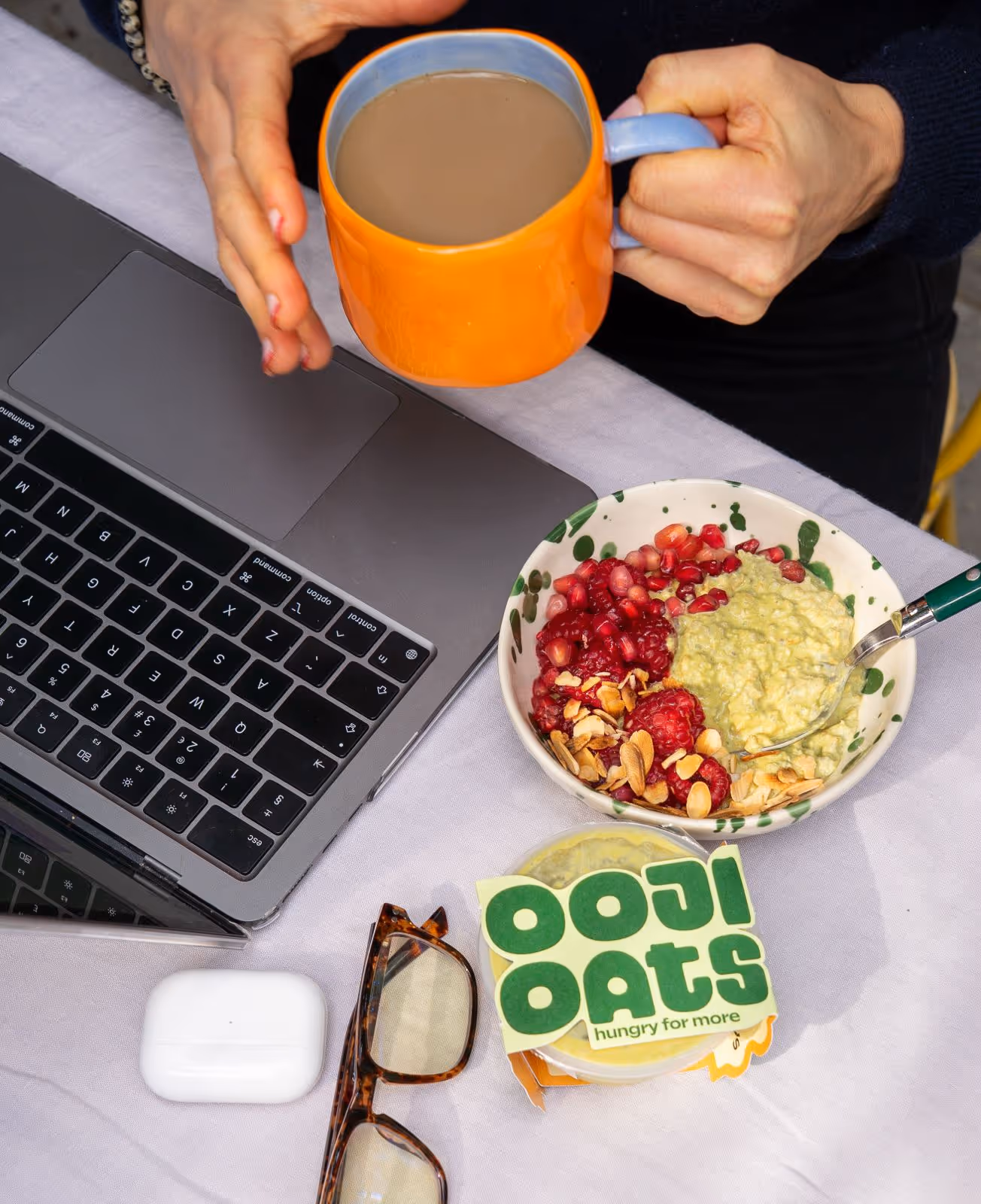 ooji oat breakfast next to a laptop and cup of tea