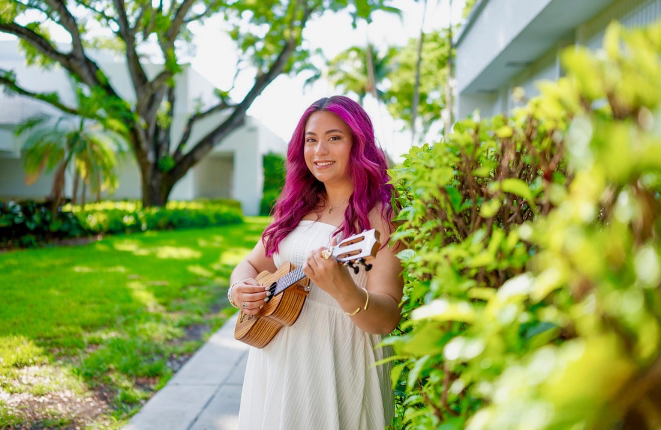 Gabriela Ocon smiling and playing a ukulele outdoors