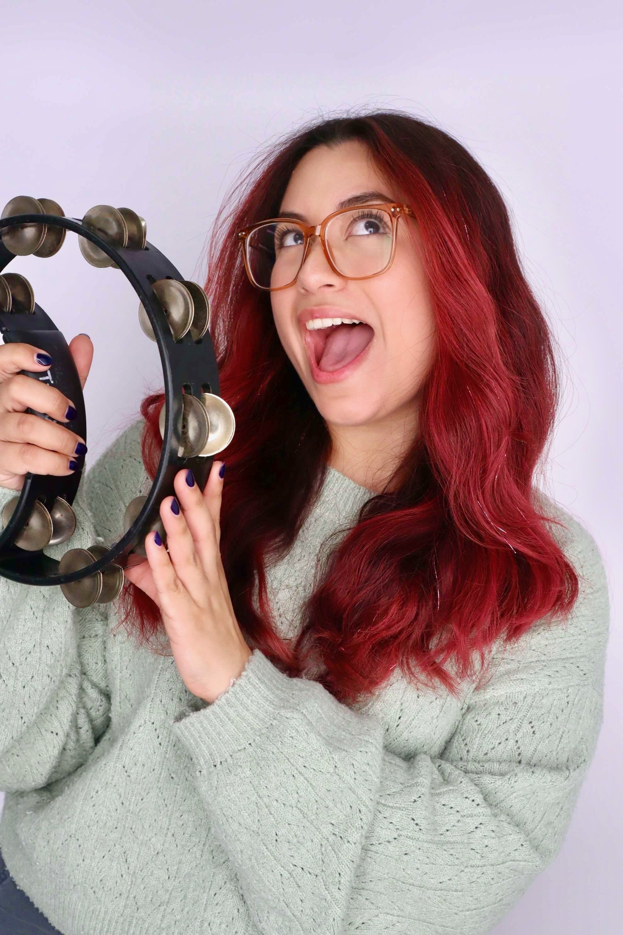 Gabriela Ocon smiling with a tambourine