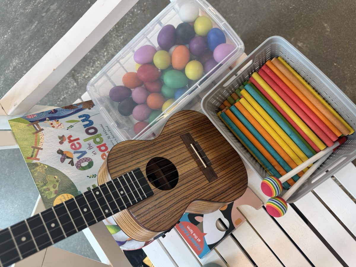Ukulele, books, egg shakers, mallets, and rhythm sticks ready for class