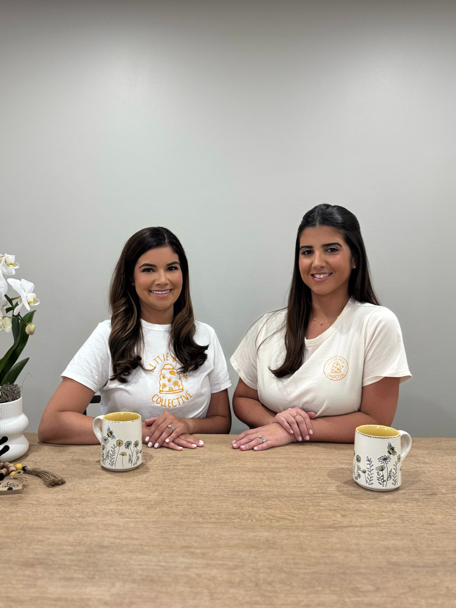 The Little Bees team seated together in branded shirts.