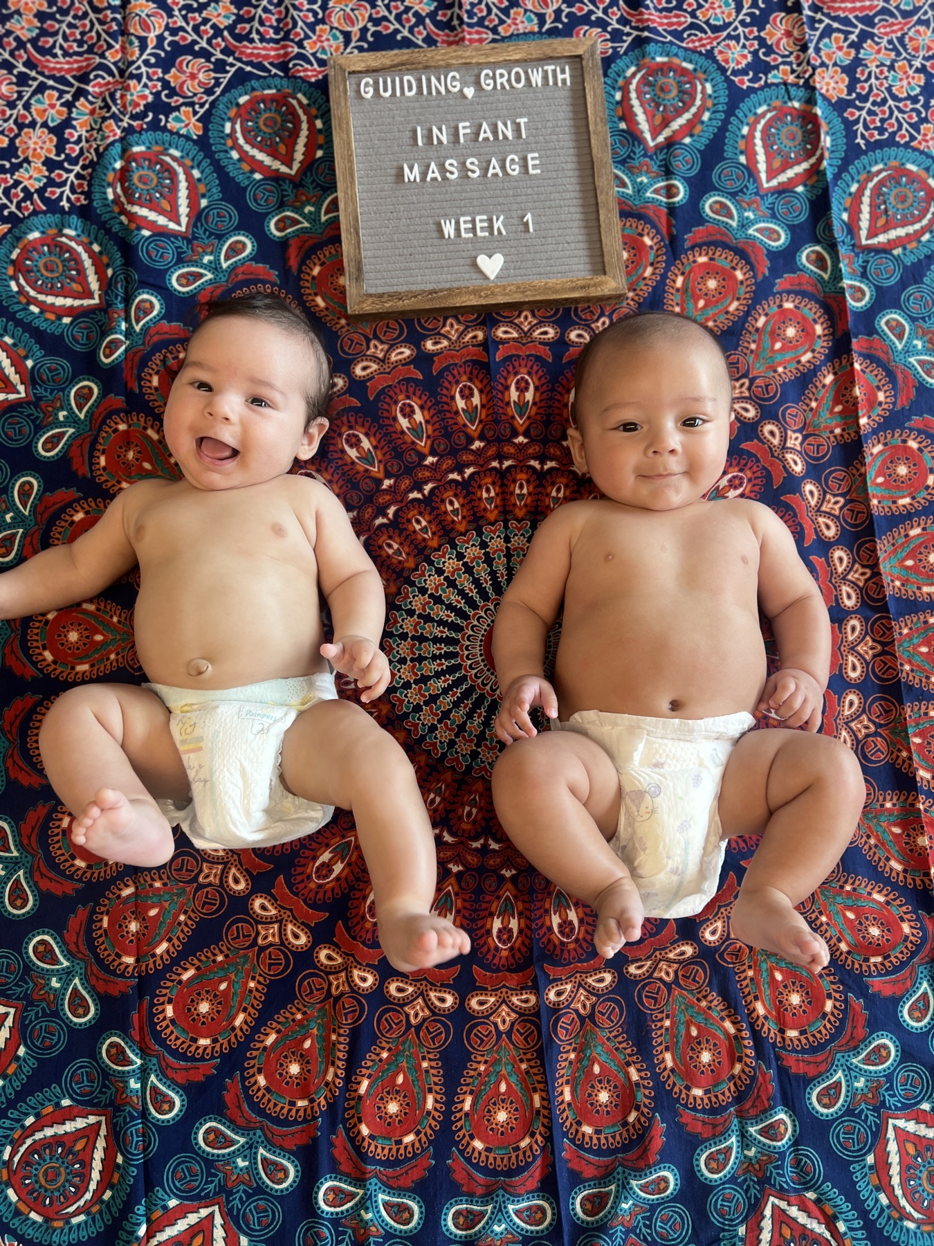 Two infants at a Guiding Growth infant massage class