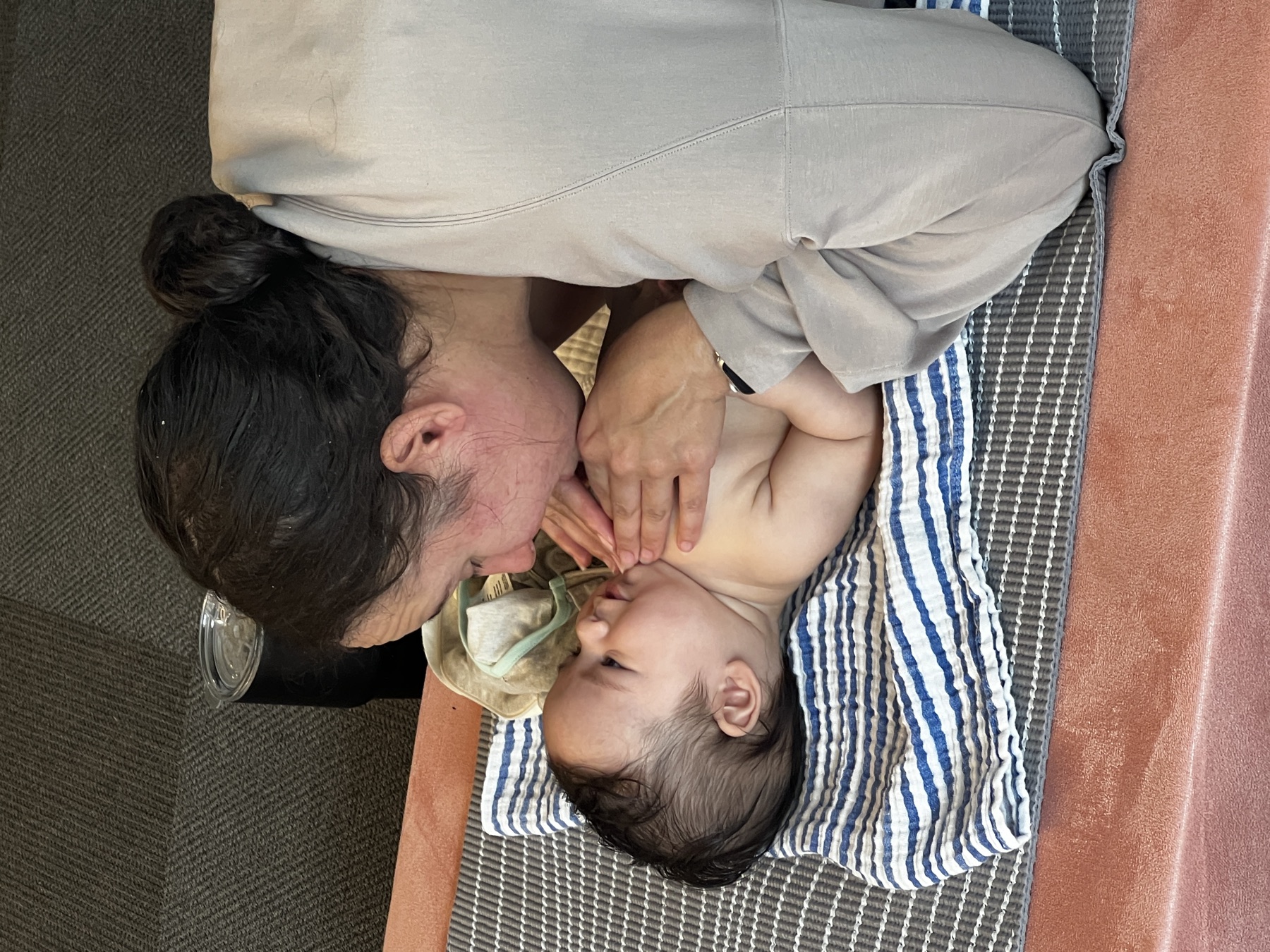 Caregiver and baby share a close moment during infant massage class