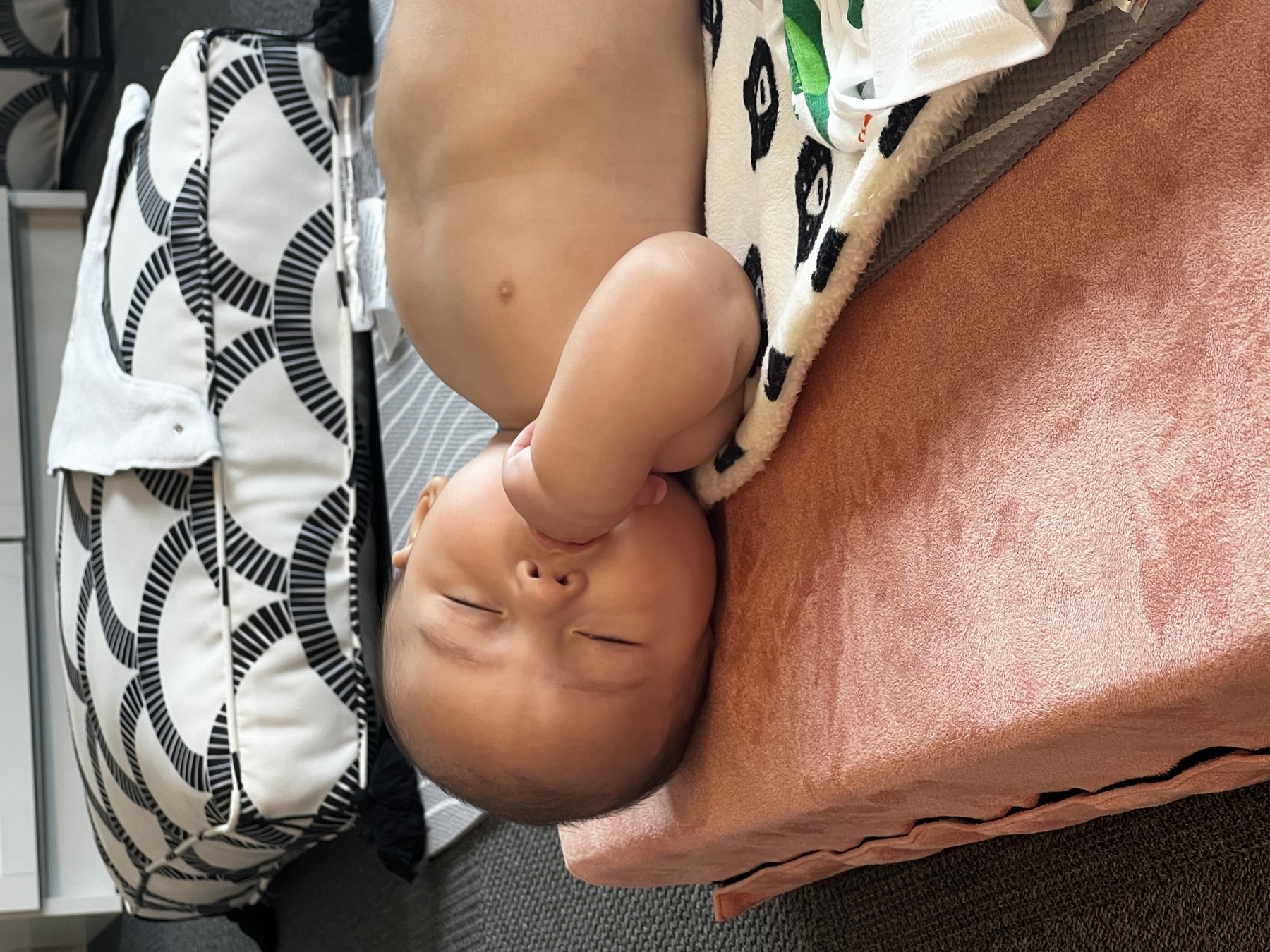 Infant resting comfortably between massage movements