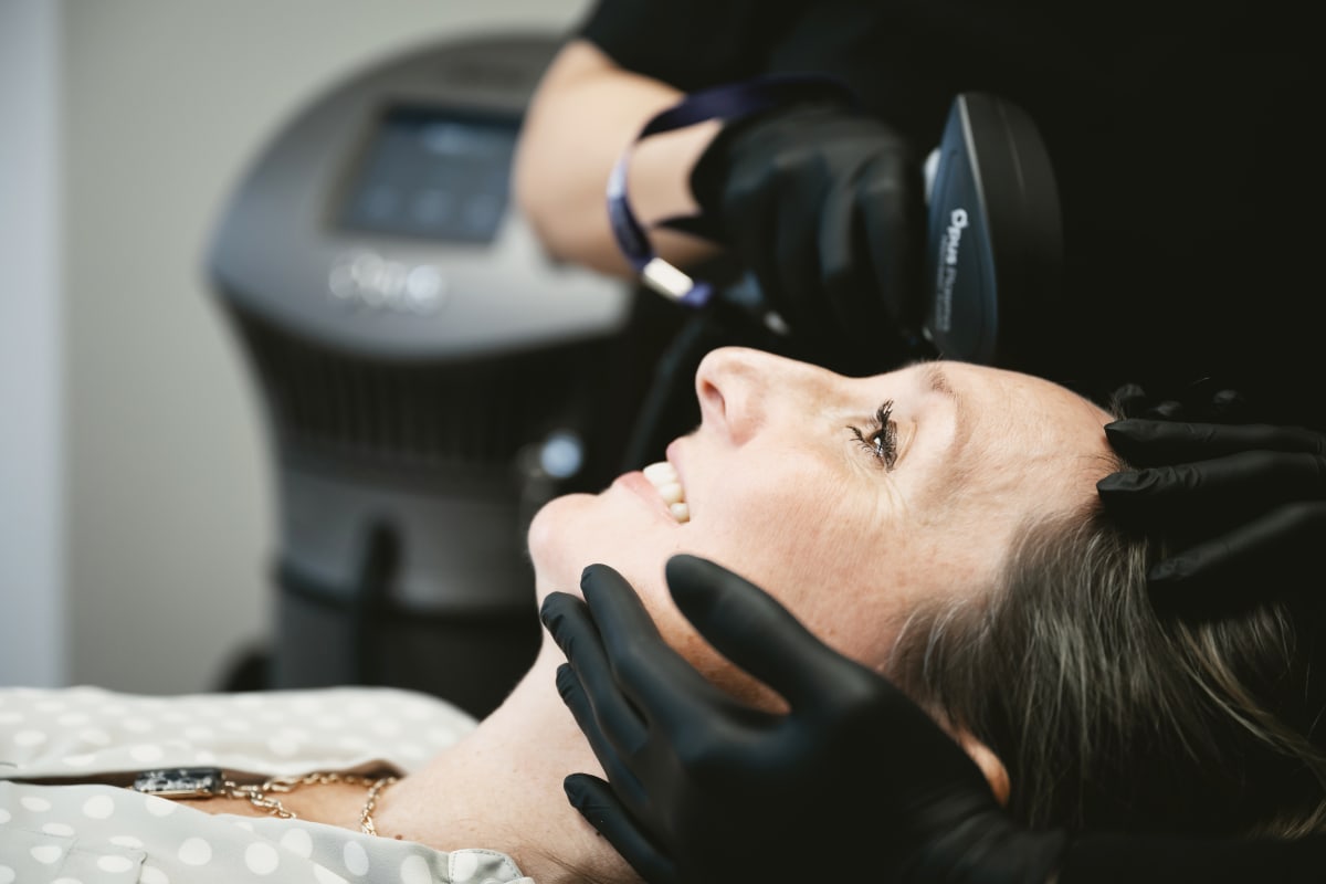 Dentist performing a clinical procedure on a patient in dental chair