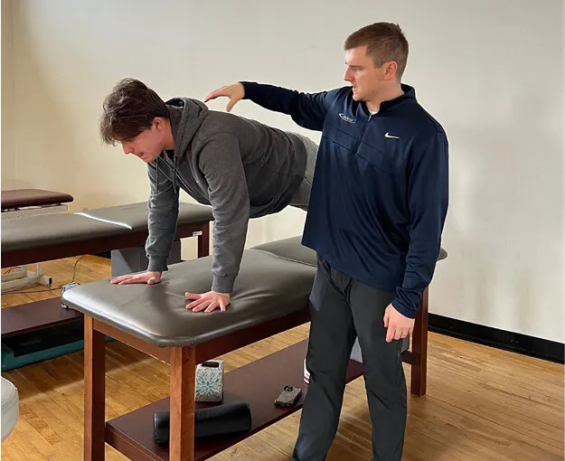bill assisting client with exercise