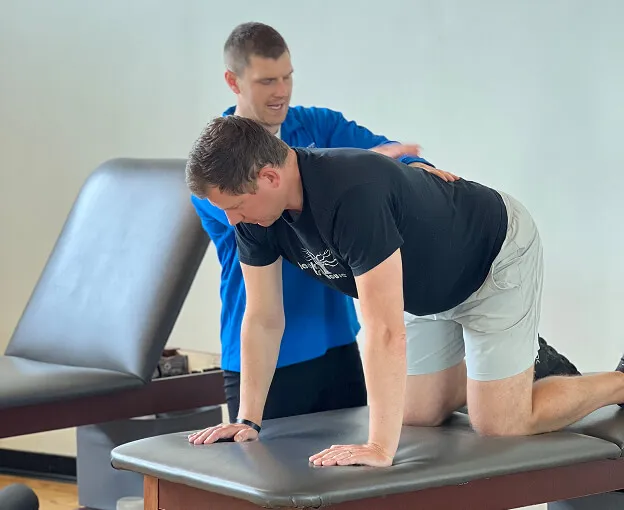 bill helping client with low back - home slider
