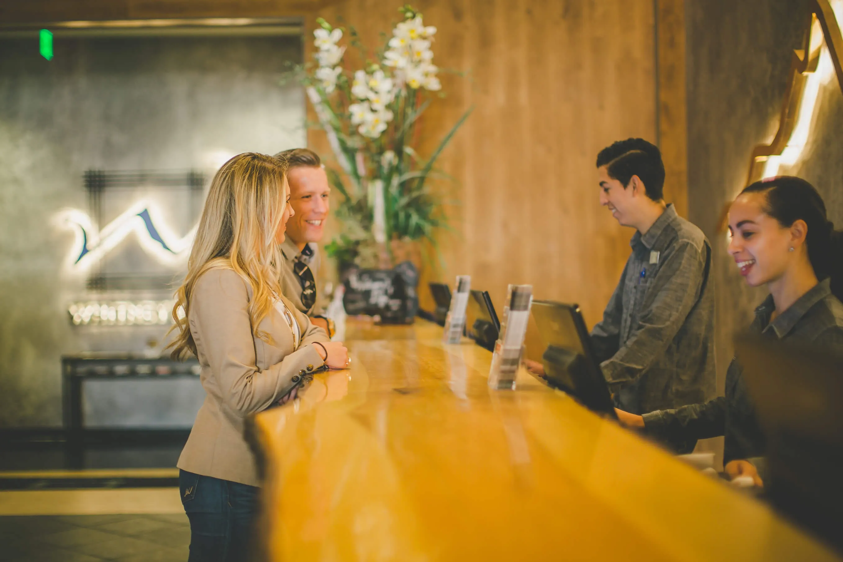 Whitney Peak Hotel team members welcoming guests at the front desk