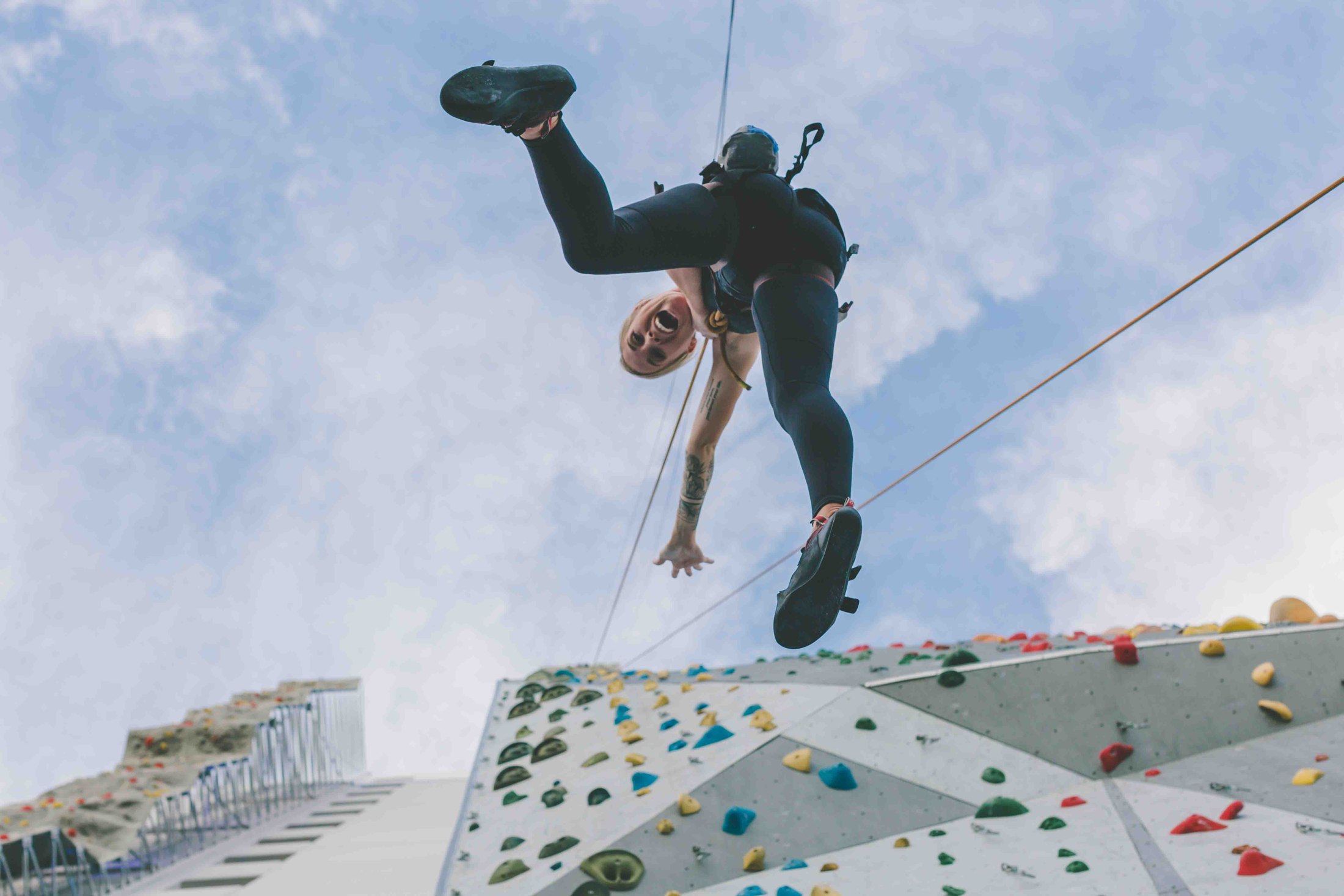 Climber above the outdoor BaseCamp wall in downtown Reno