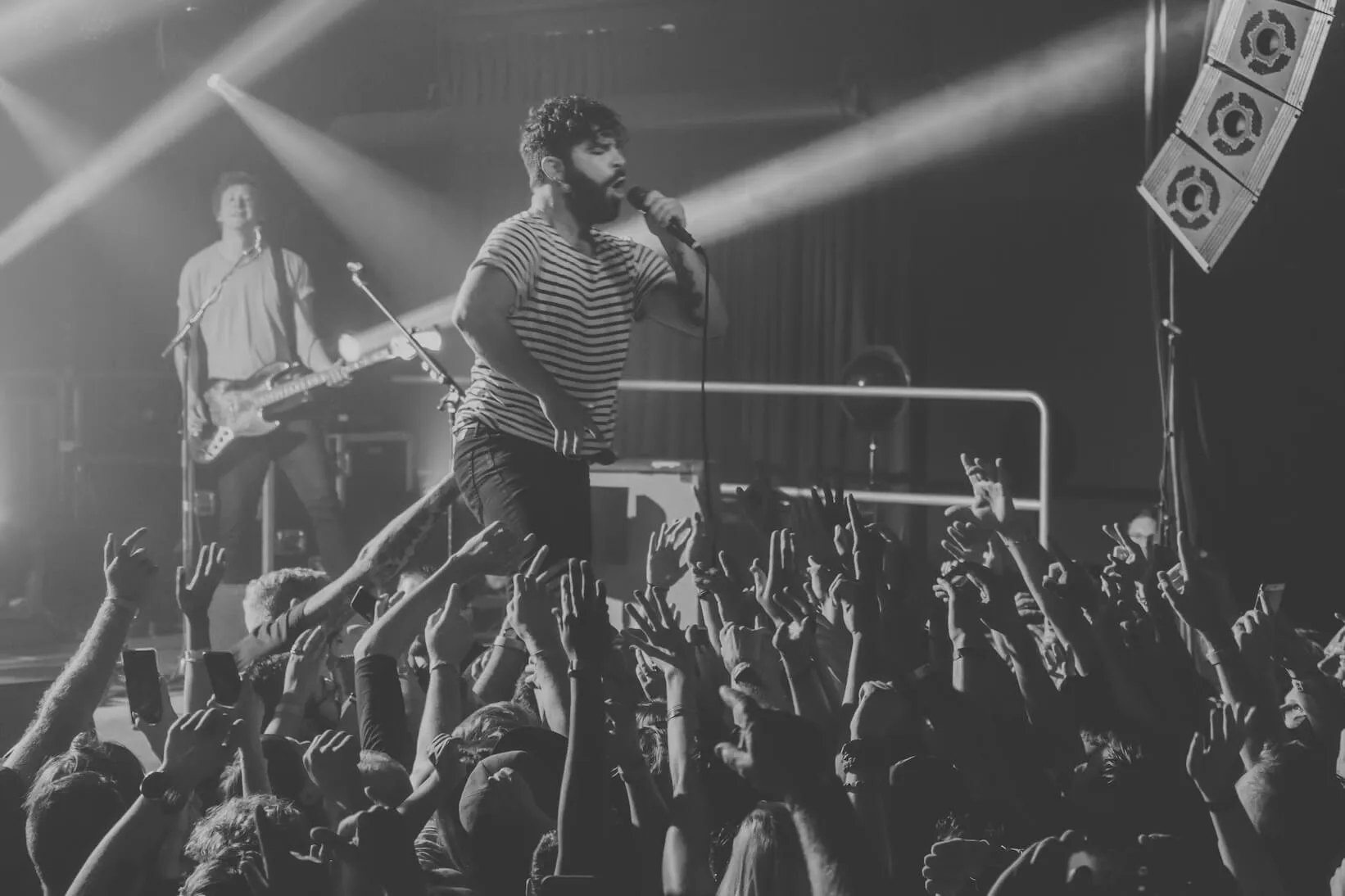 Singer reaching toward the crowd during a show at Cargo Concert Hall