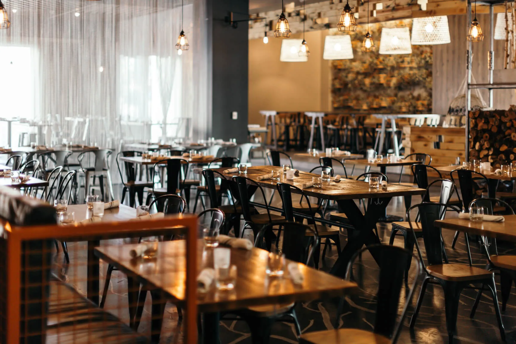 Tables set for service inside Café Whitney