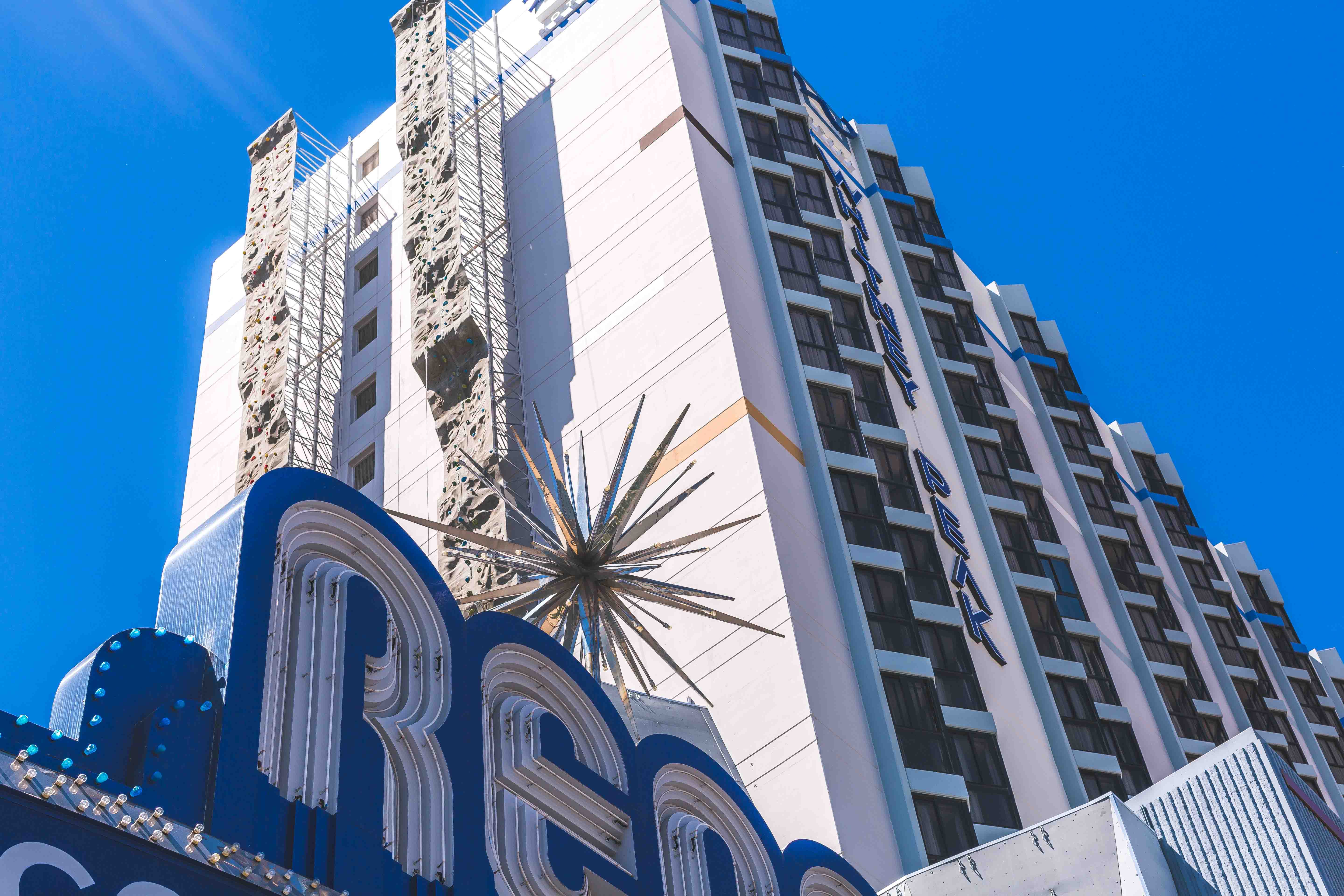 Whitney Peak Hotel rising above the Reno Arch, with the outdoor climbing wall on its facade